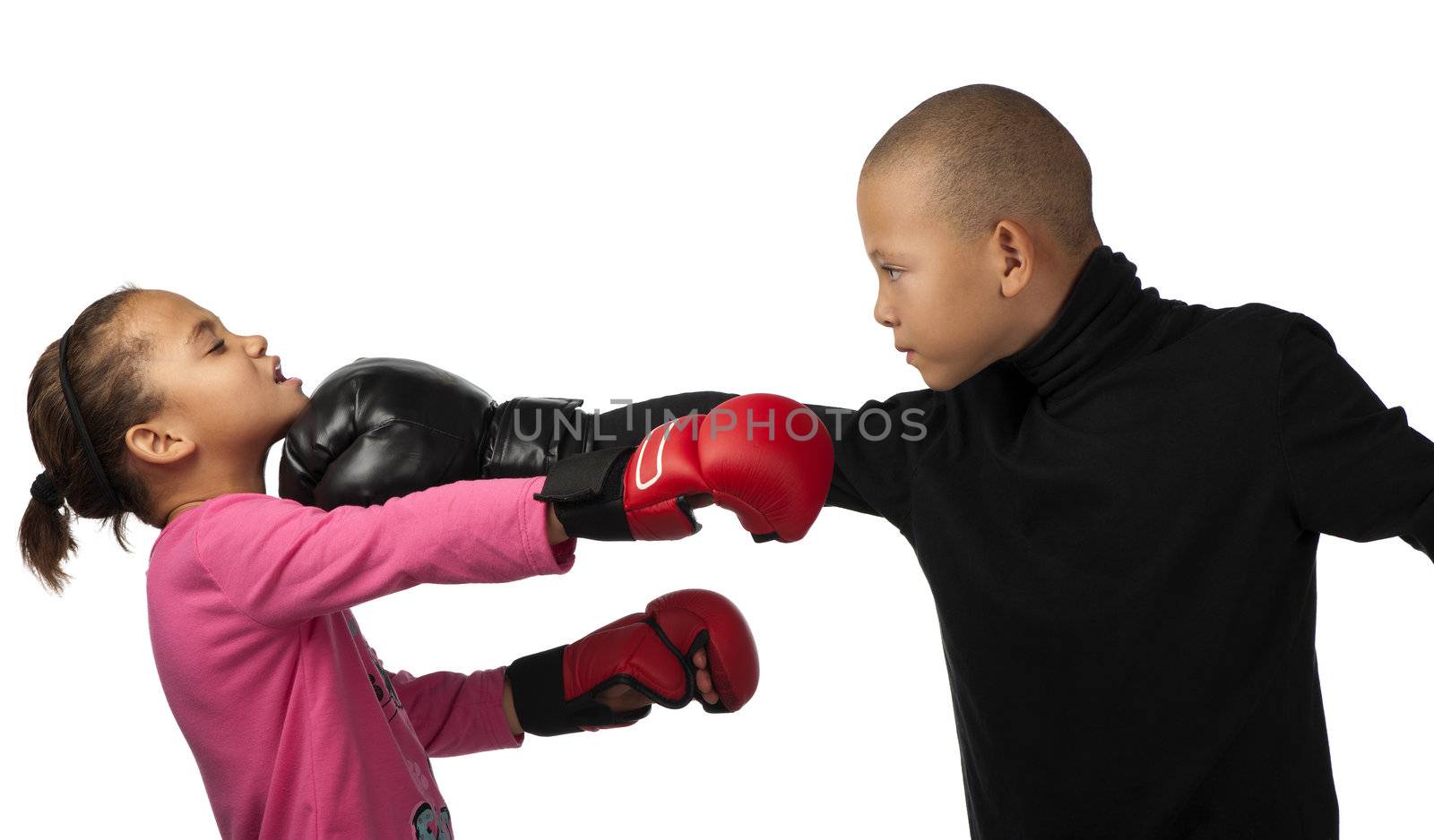 A boy punches a girl on the chin during a boxing contest.