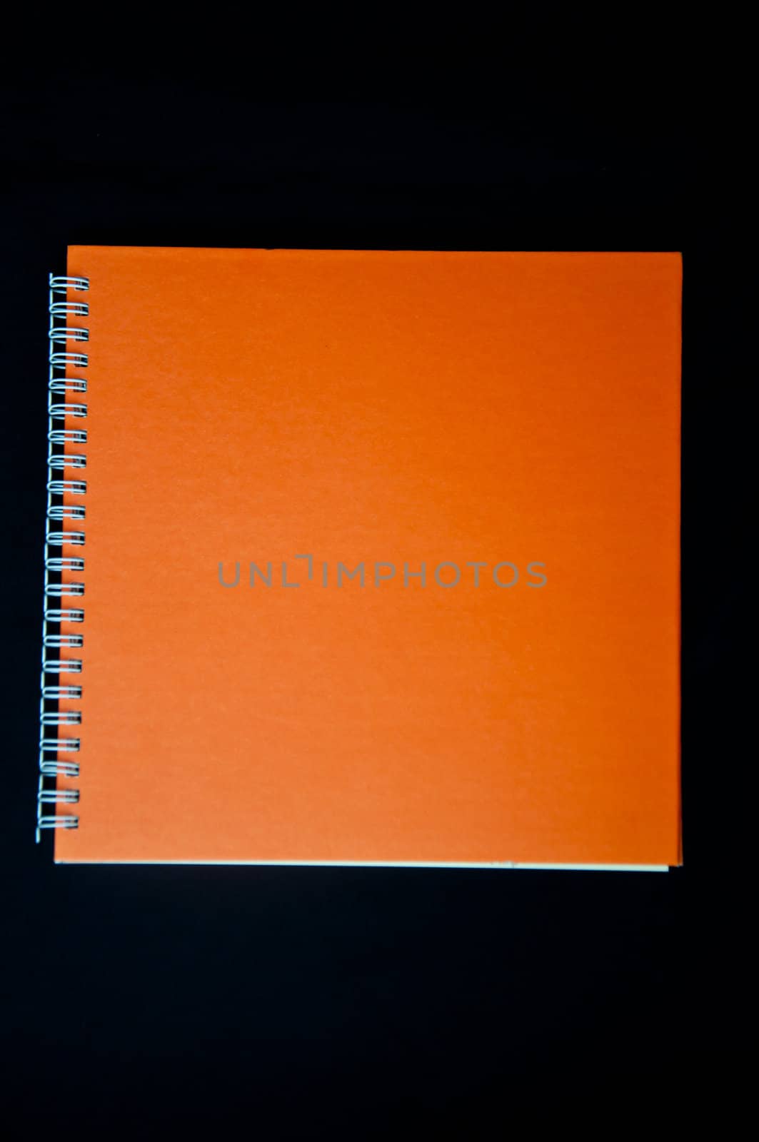 orange notebook  on black background