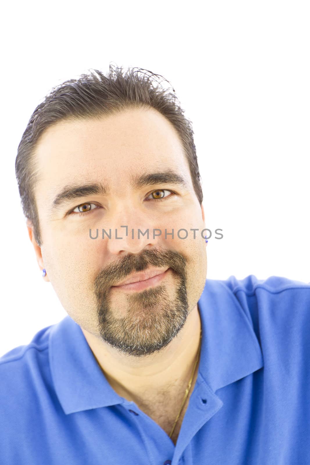 Positively smiling man with goatee and blue shirt.