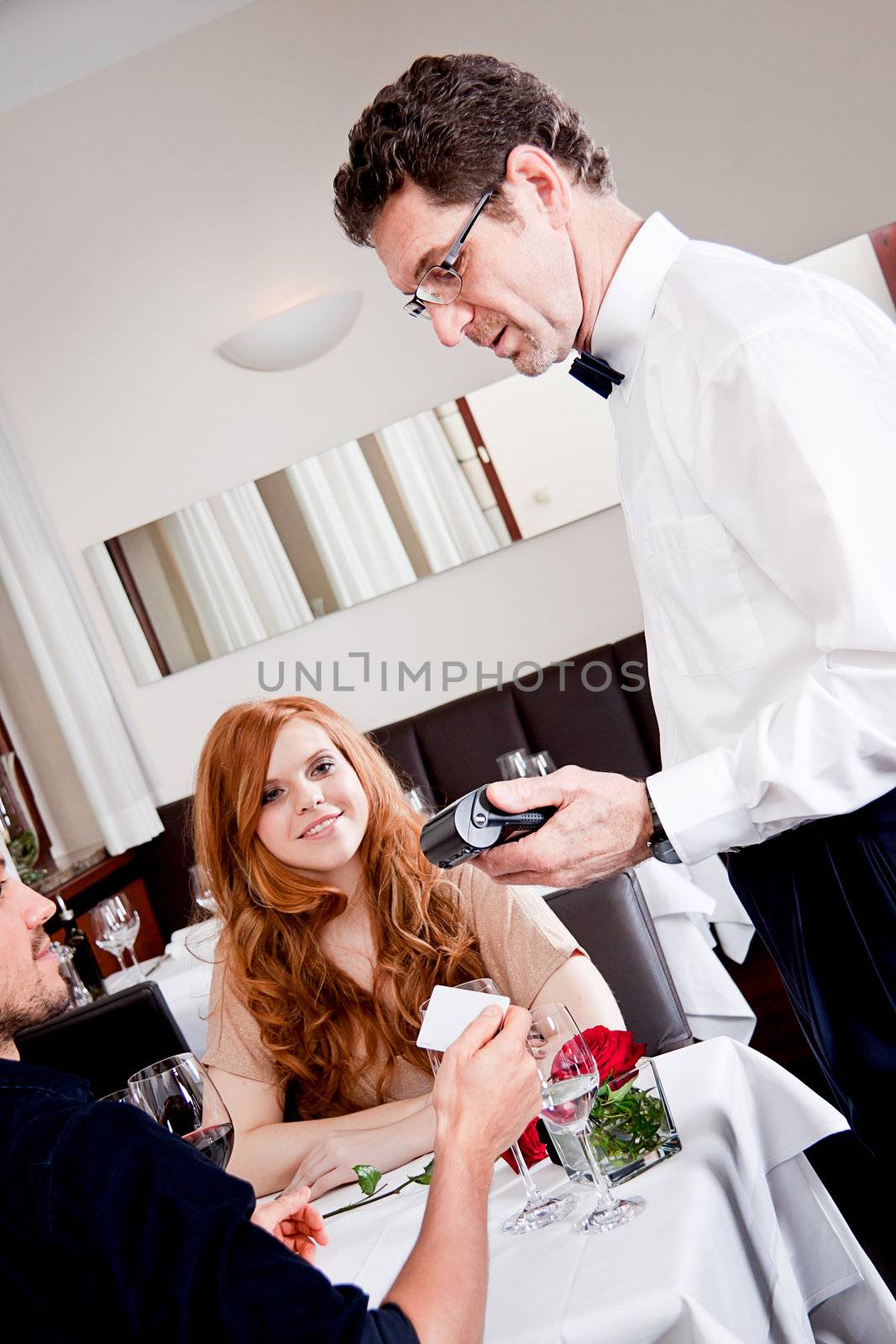 happy couple in restaurant pay cash free  by credit card electronic security money