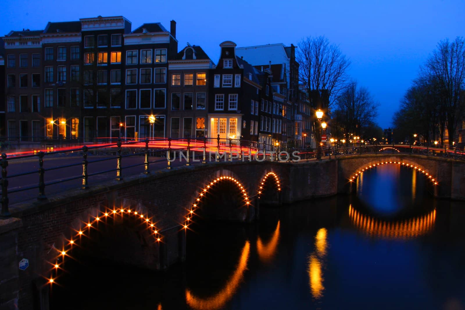 Amsterdam Canal at Dusk with Light Trails, taken on cnr of Reguliersgracht and Keizersgracht. Time Exposure. Landscape Orientation.