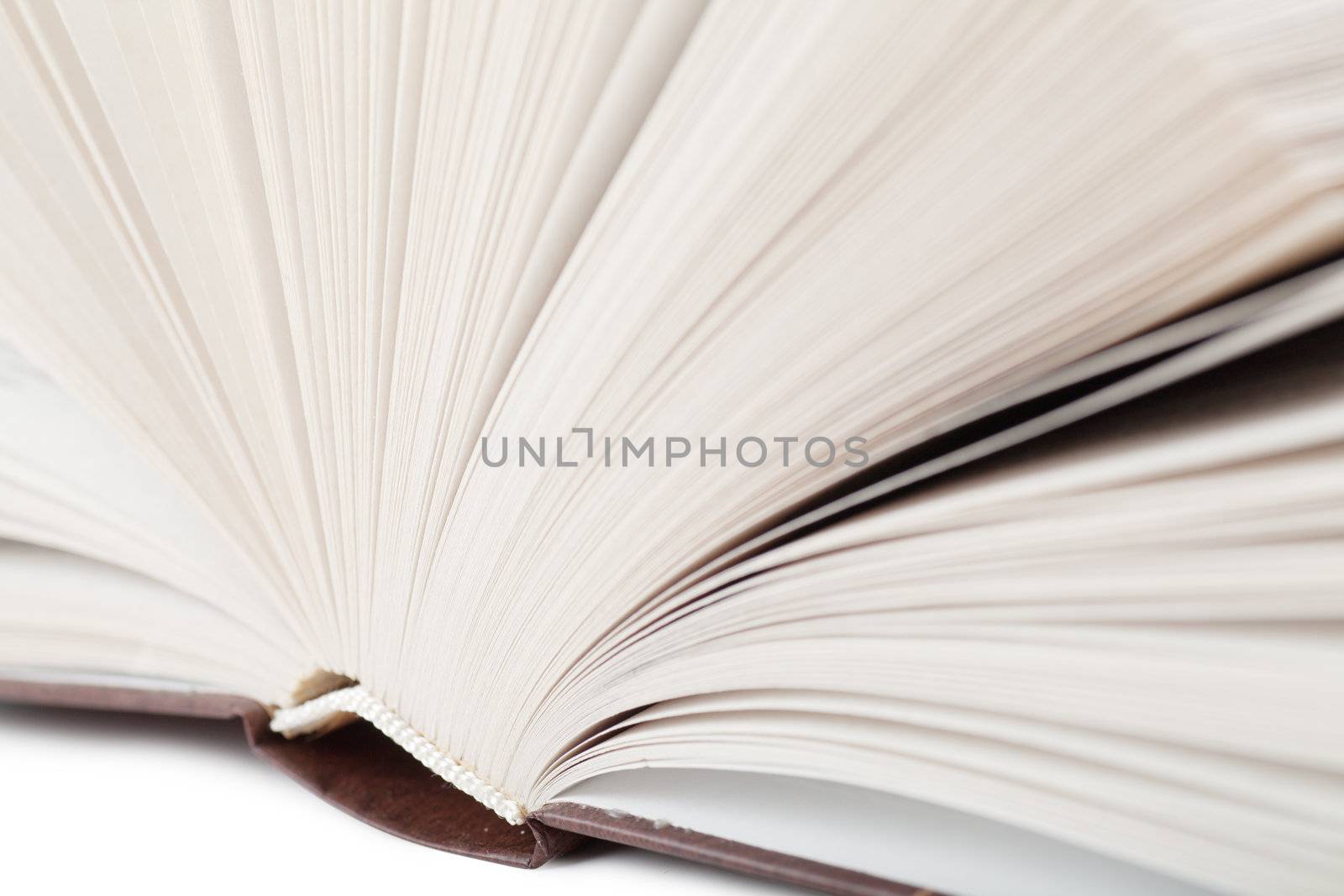 Macro view of binder of thick book over white background