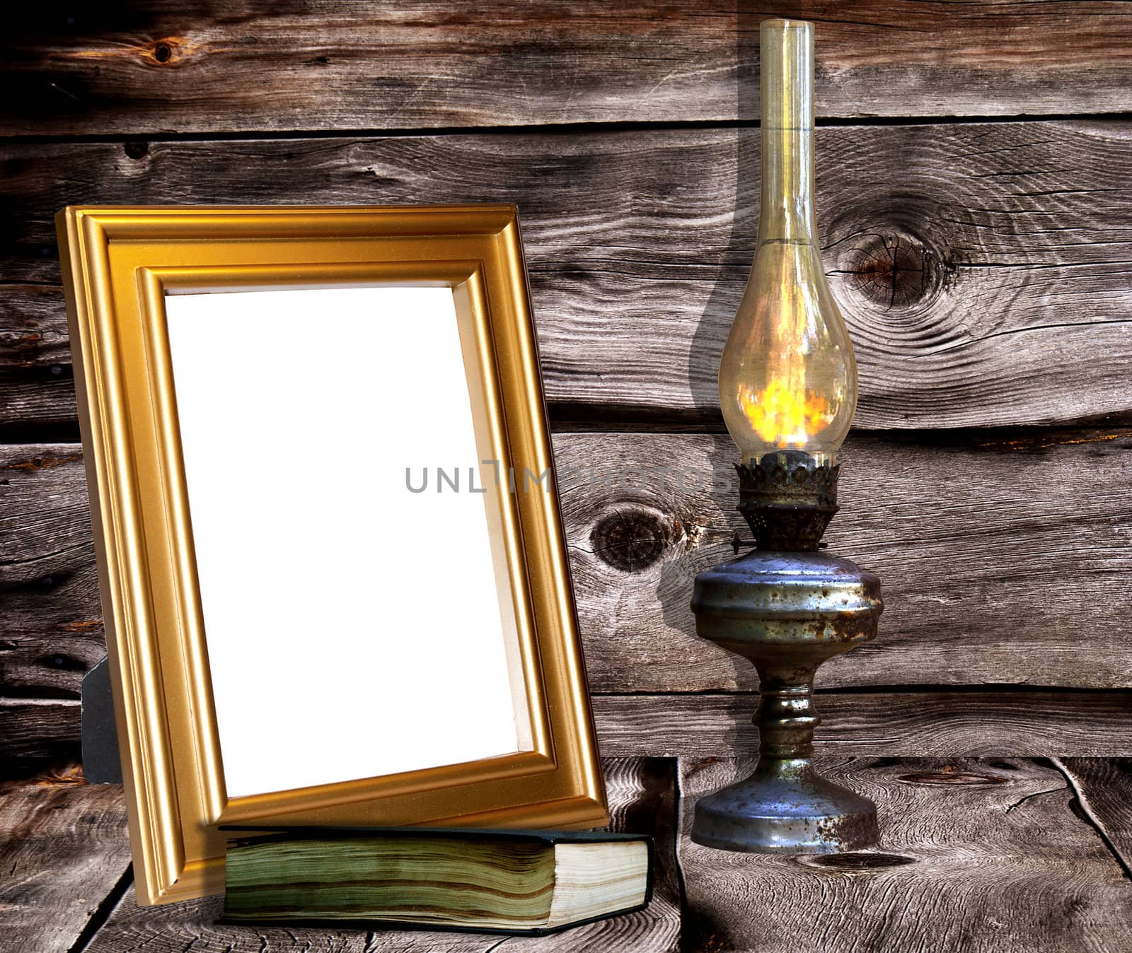 Old rusty lamp against  and decorative retro frames for a photo dark wooden boards