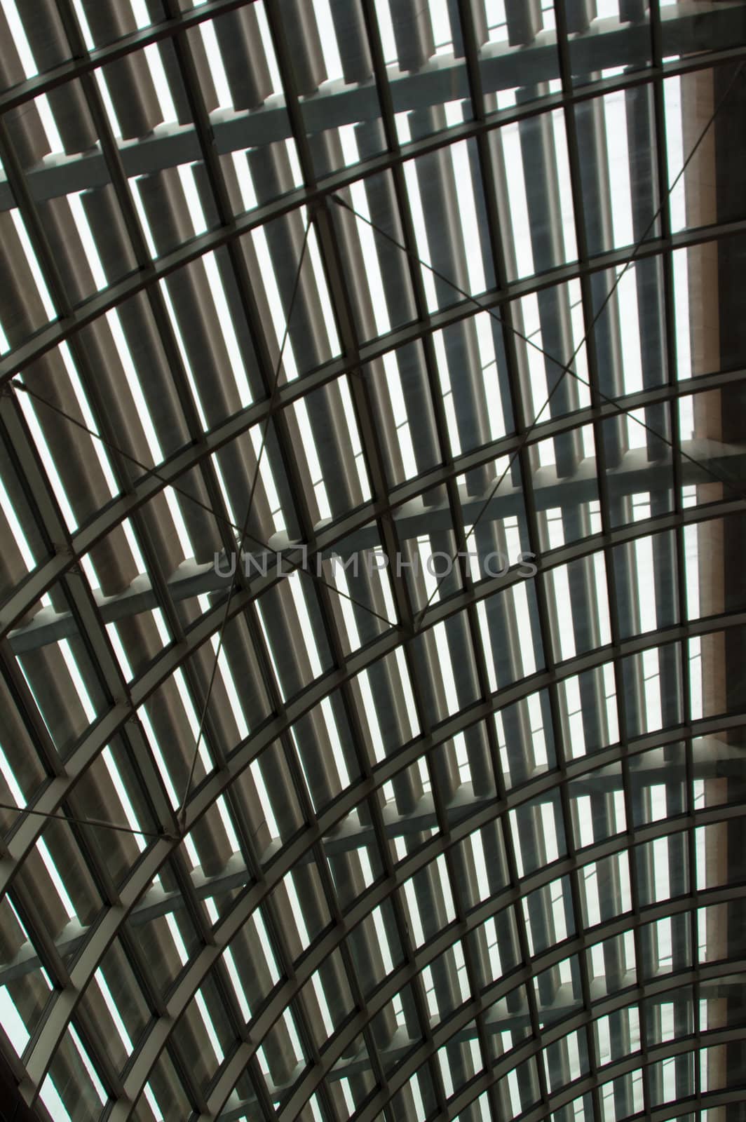Closeup of a curved reinforced steel roof with glass panes