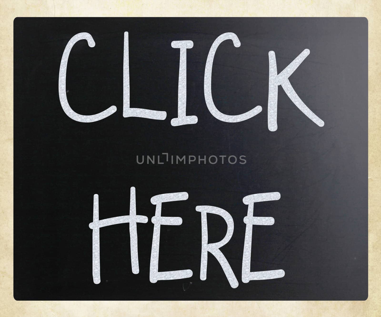 "Click here" handwritten with white chalk on a blackboard