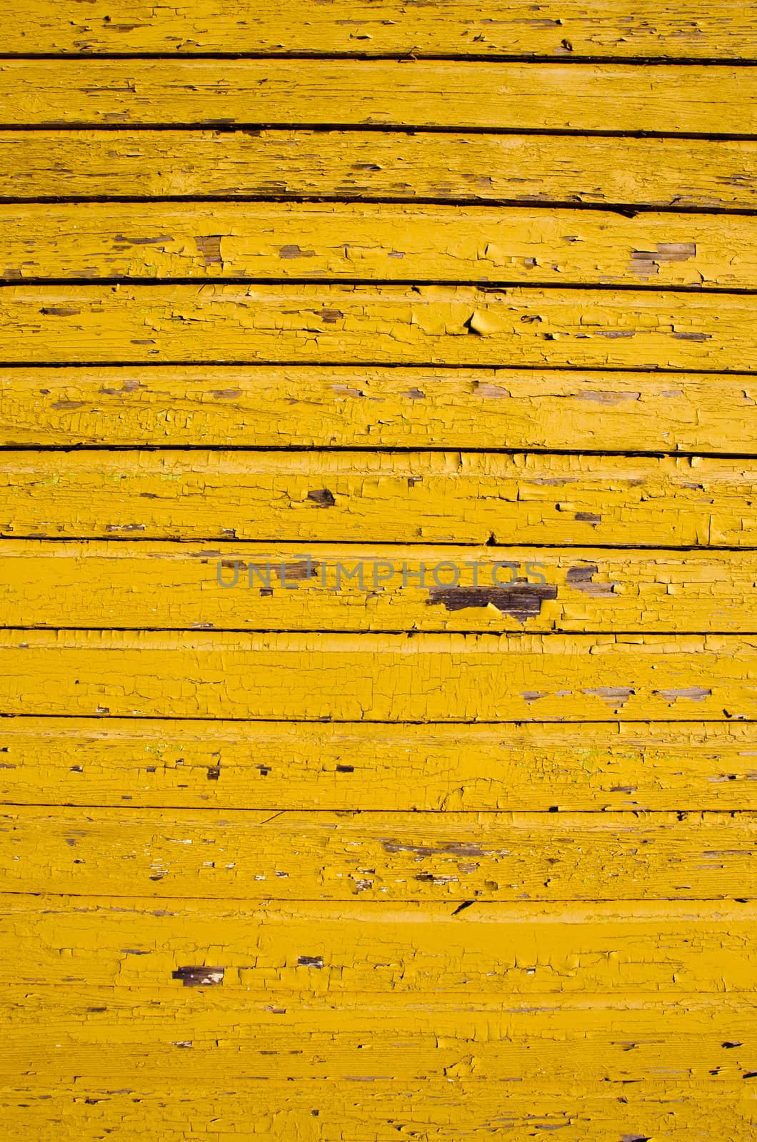 ancient retro yellow painted wooden wall with peeling paint background.