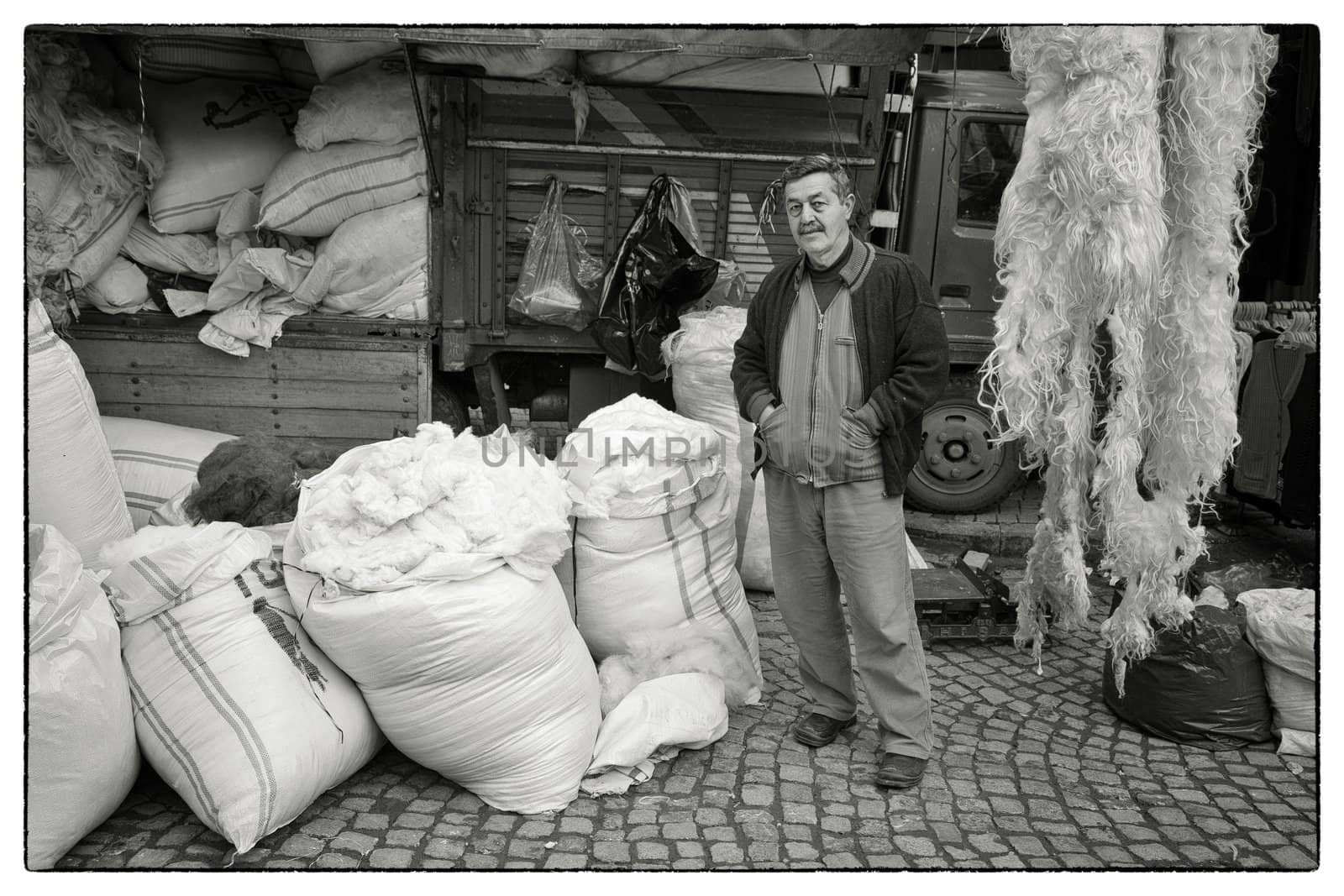 TURKISH WOOL SALESMAN, ISTANBUL, TURKEY, APRIL 11, 2012: Man in front of his wool shop near the bazaar in the Fatih district of Istanbul, Turkey.