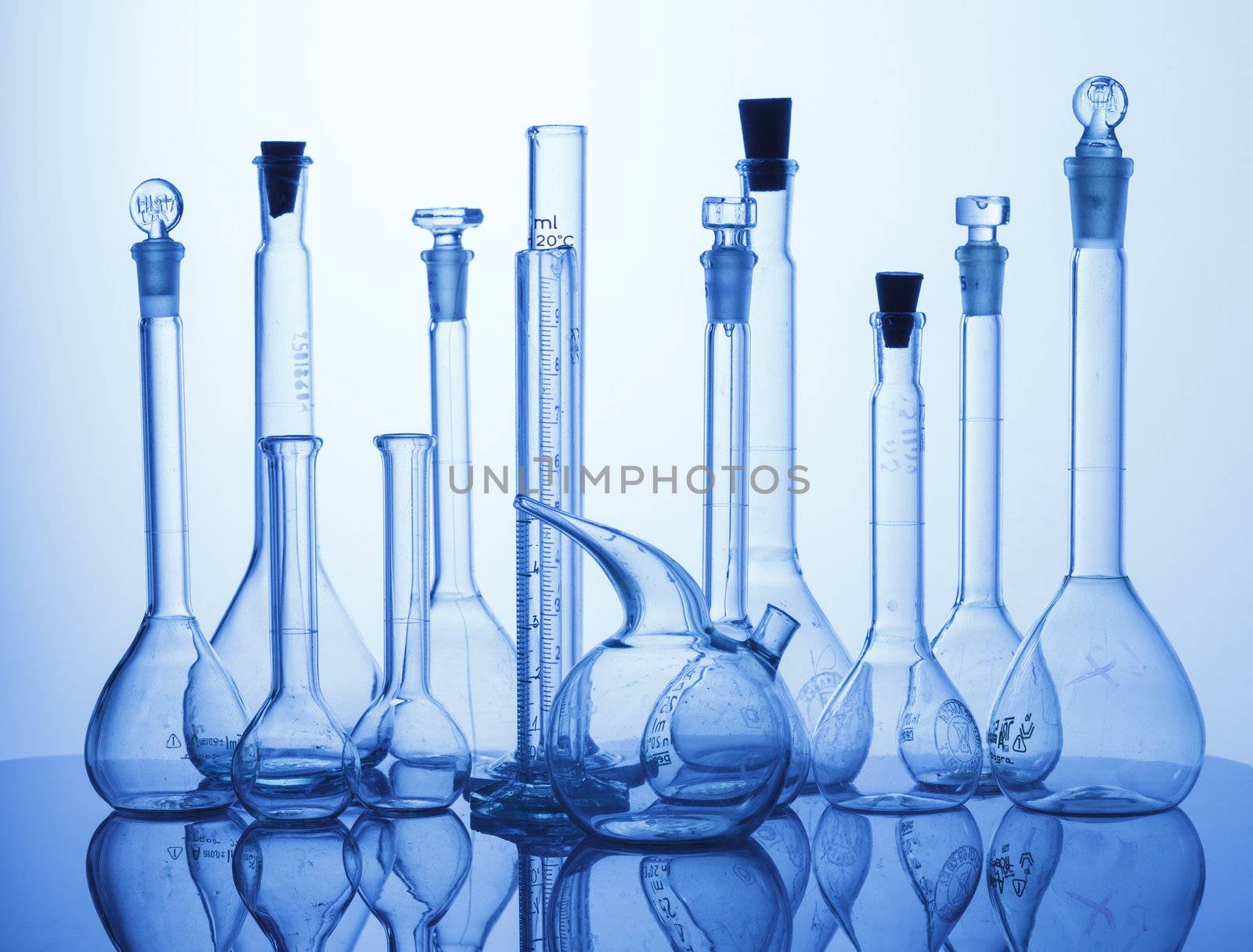 Research Lab assorted Glassware Equipment on blue background