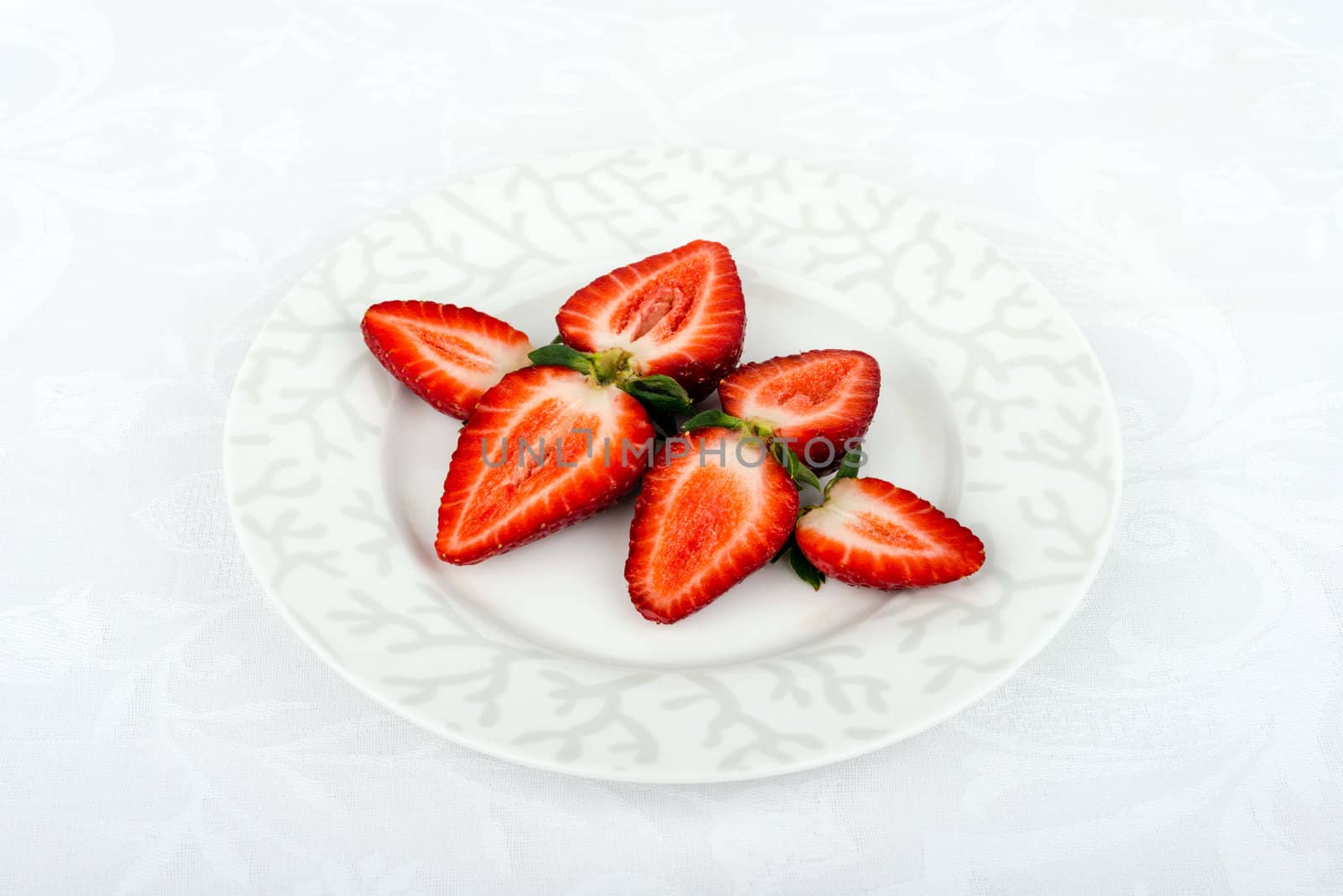 Some fresh strawberries on the plate.