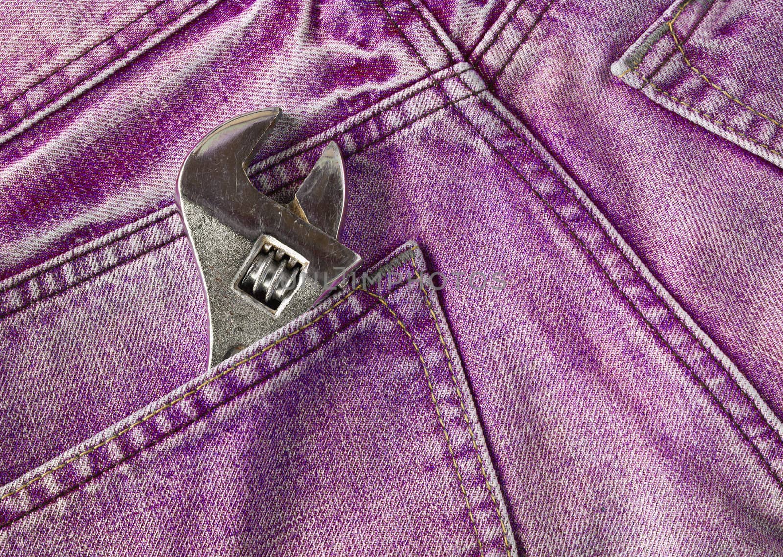 Red jeans pocket with old tool