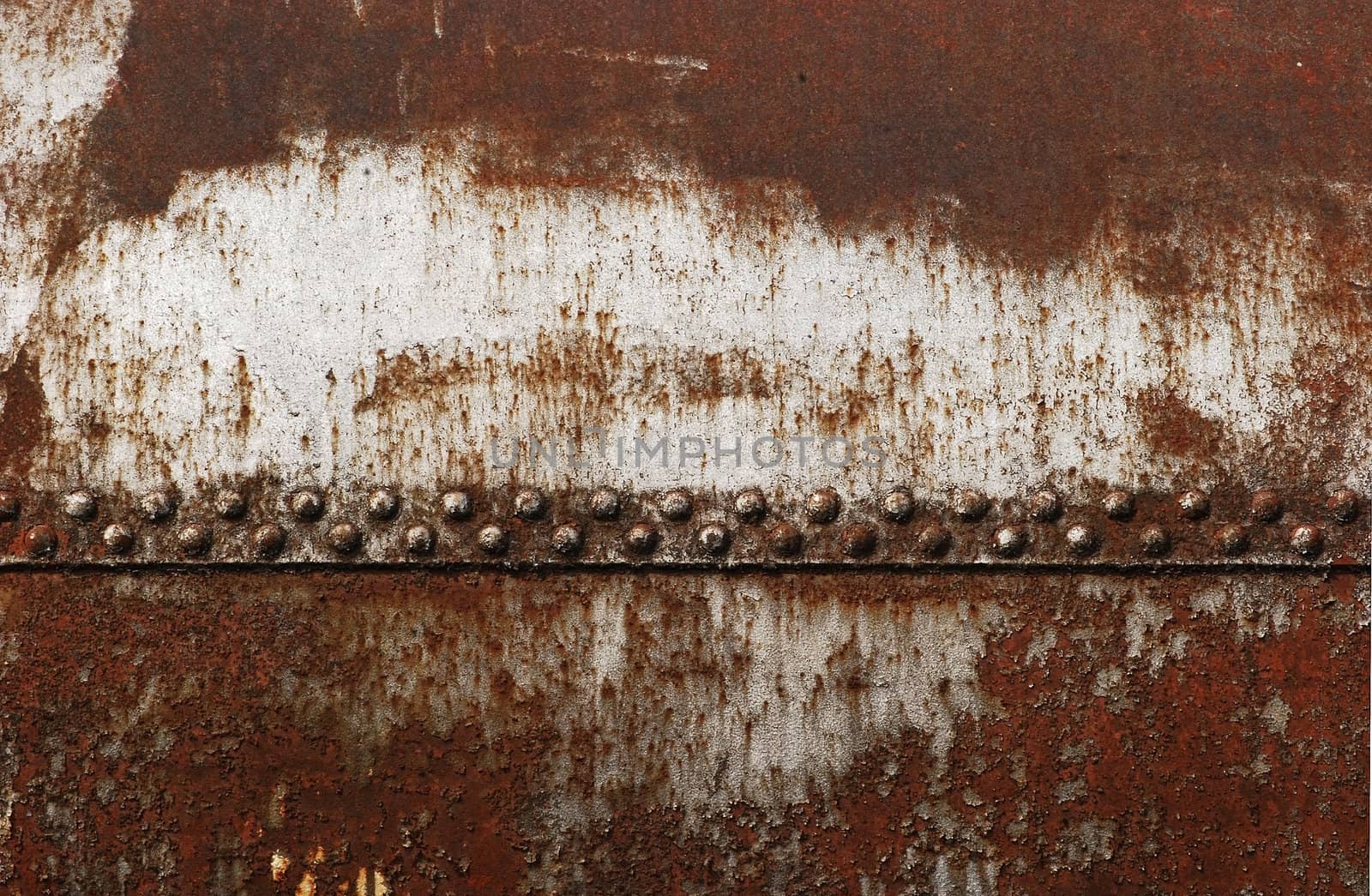 Old rusty railway cistern riveted joint as background