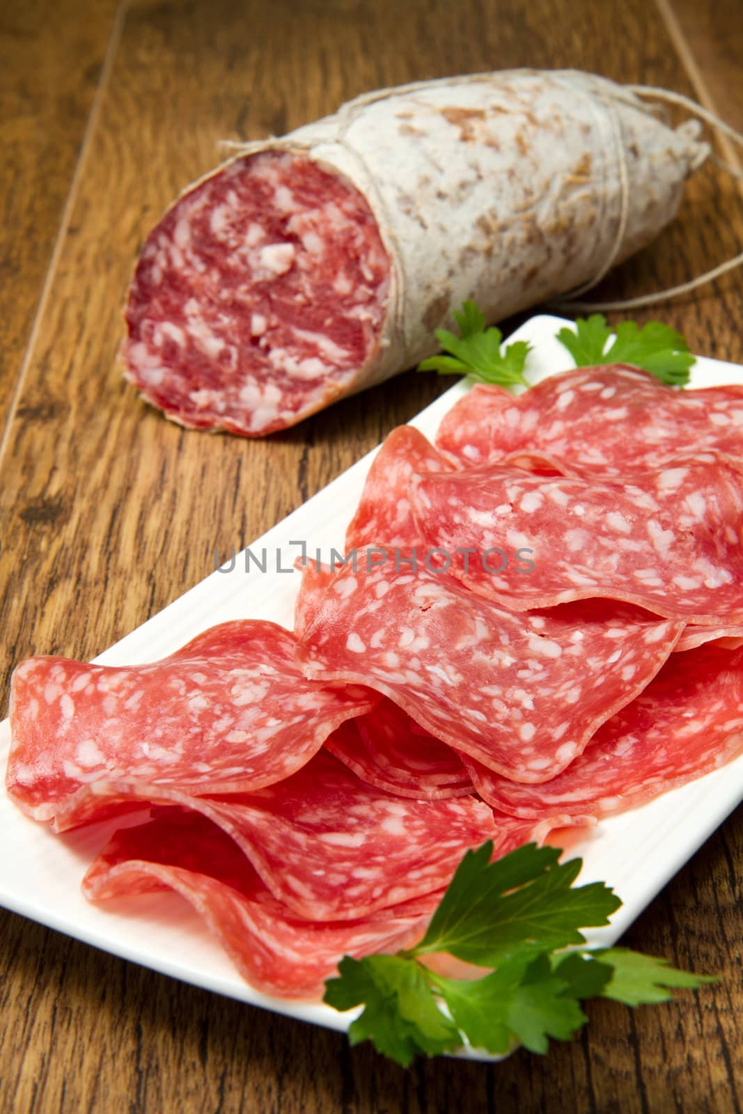 Salami sliced on wood background