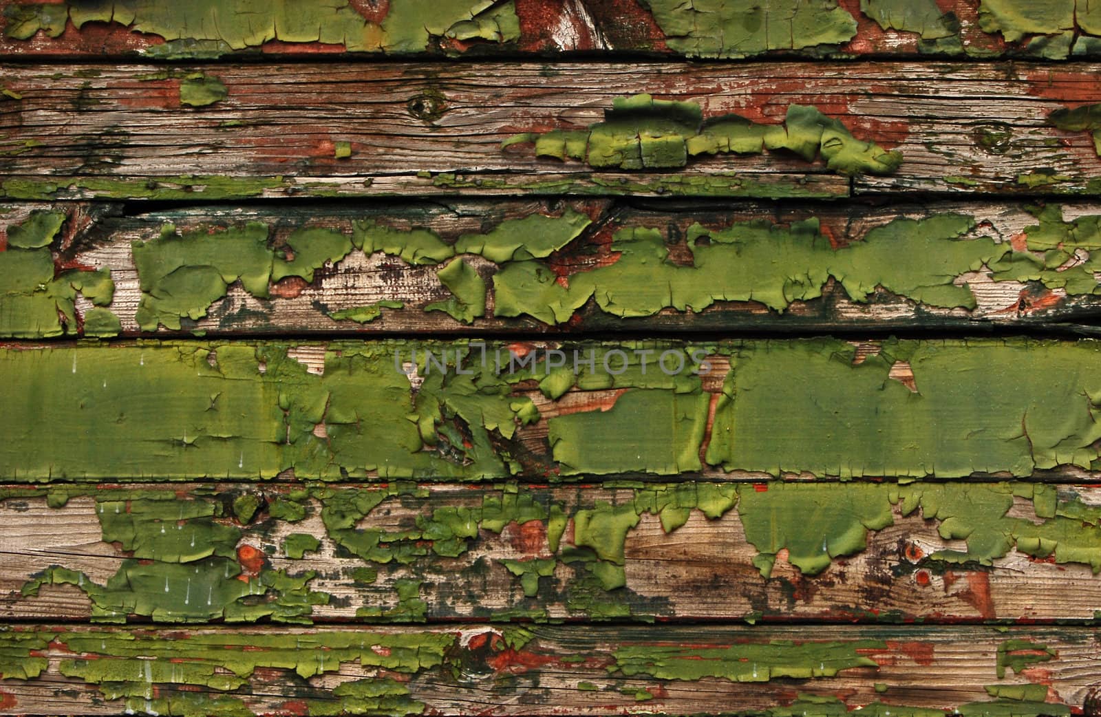 Old railway wagon wooden side green boards peeled coats as background
