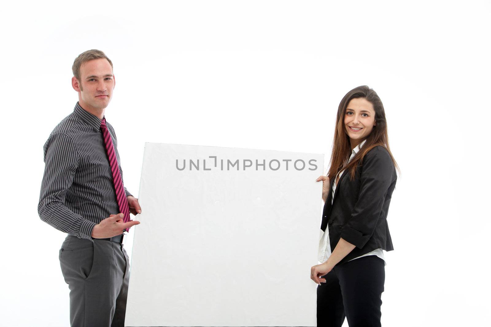 Young businessman and businesswoman holding a large blank poster with room to place your mesage