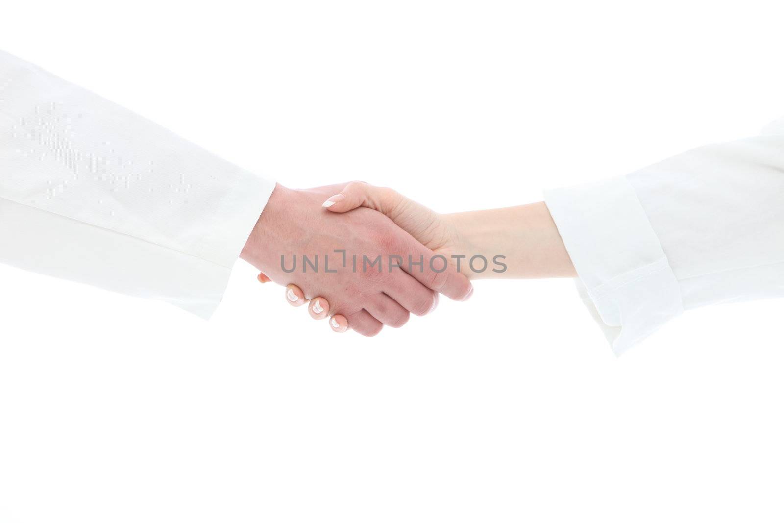 Cropped view of a male and female hand in white medical uniform sleeves clasped in a handshake conceptual of a greeting, success, thanks or agreement