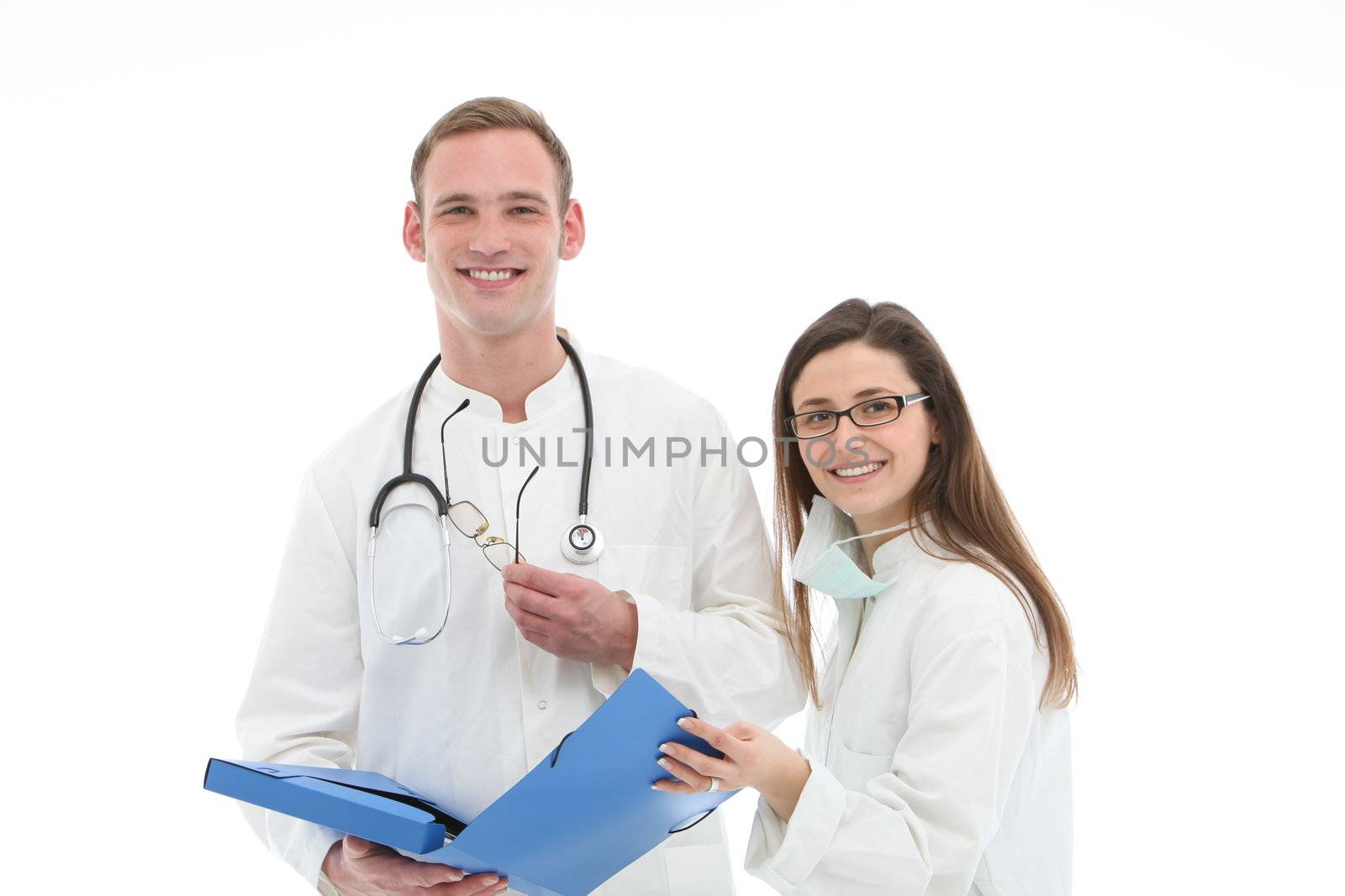 Smiling young male doctor and his female assistant or nurse standing holding a blue folio discussing patient records