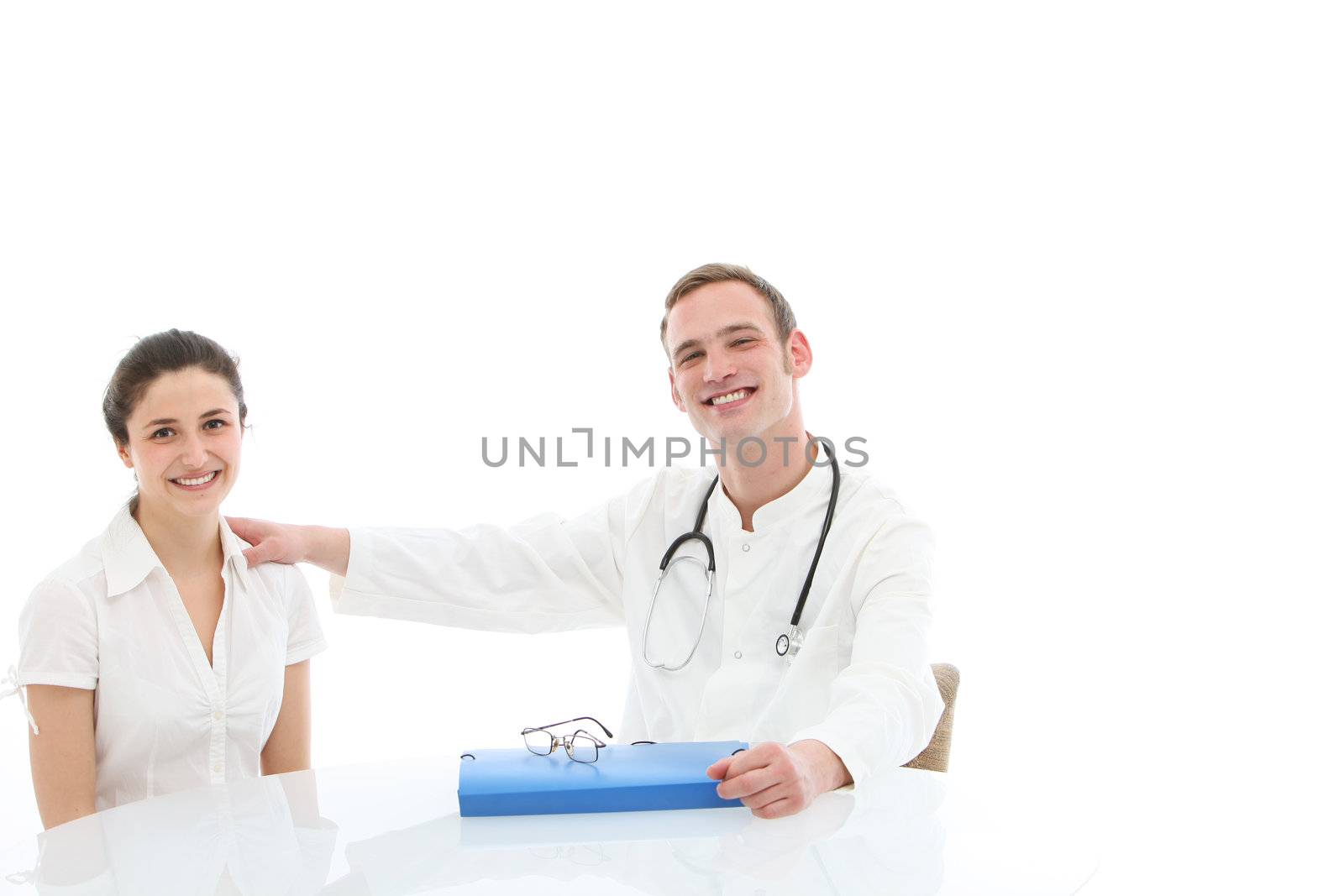 Young doctor with a folio of the patient's records sitting at a table in consultation with a female patient