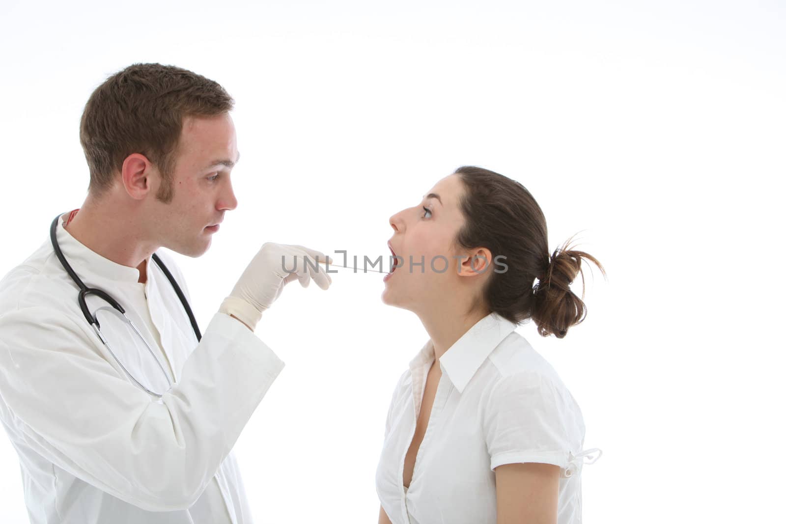 Young doctor examines throat of his patient on white background