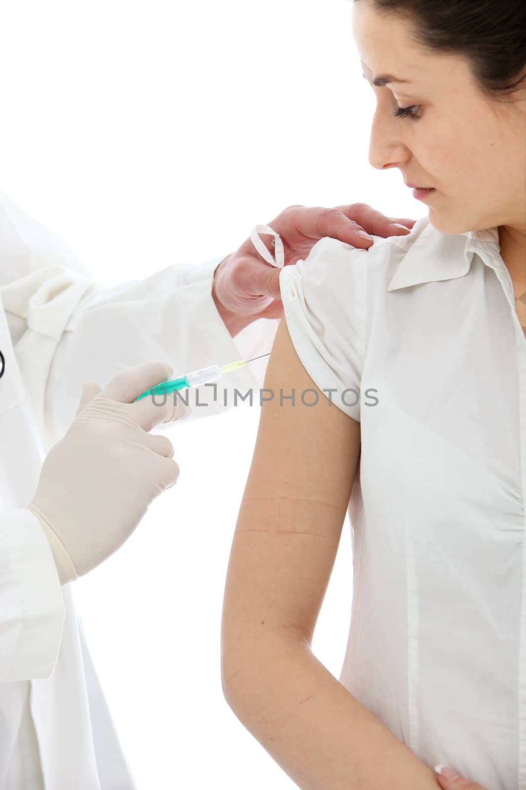 Female patient receiving an intramuscular injection in her upper arm isolated on white