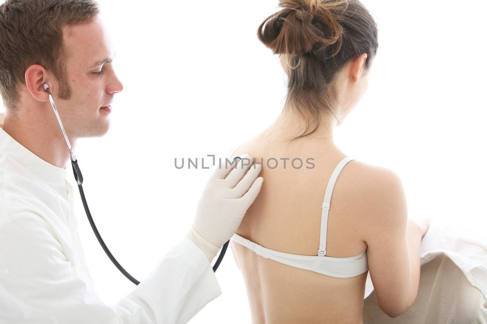 Doctor using a stethoscope to listen to a female patient breathing isolated on white