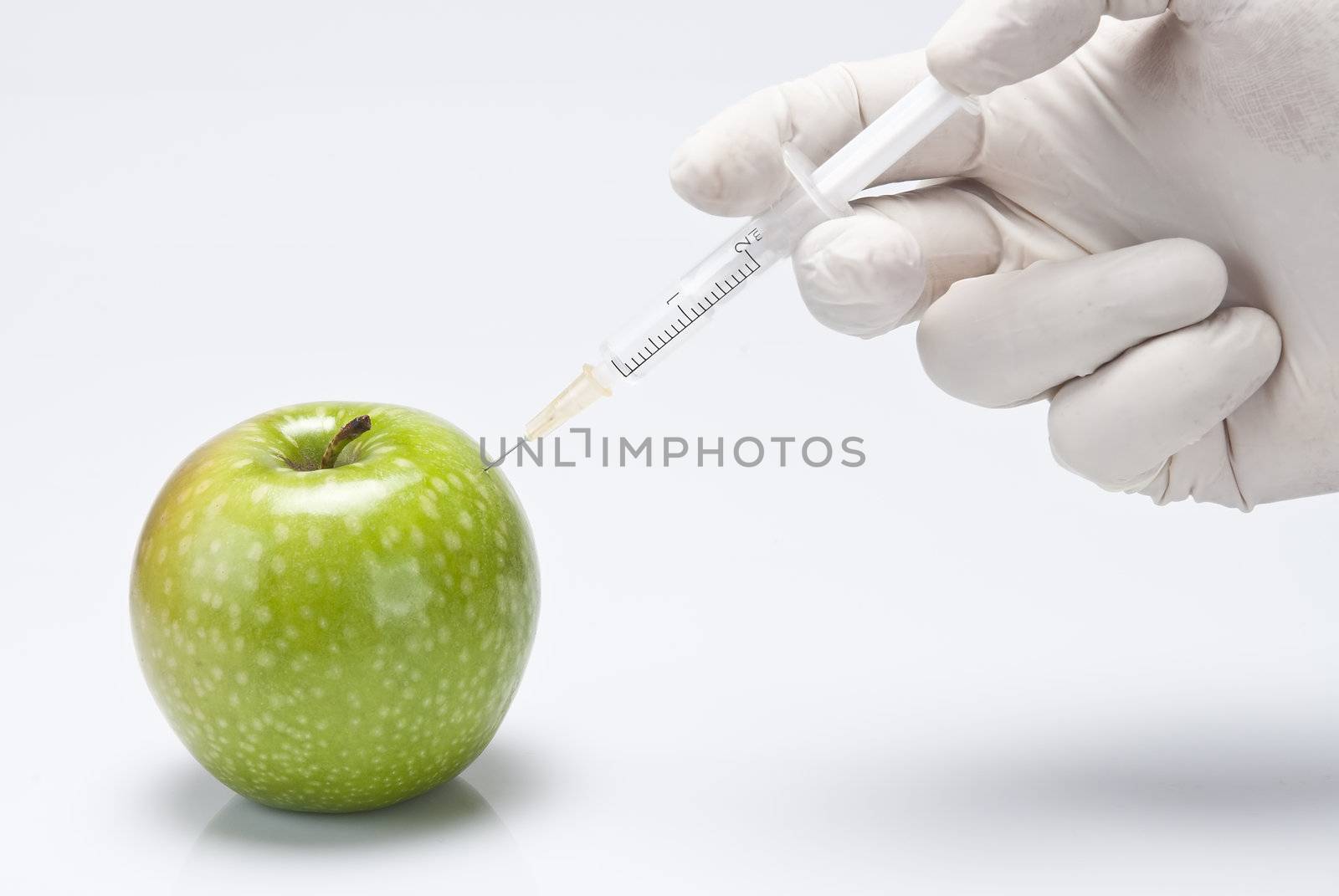 Injecting a fluid into an apple. by angelsimon