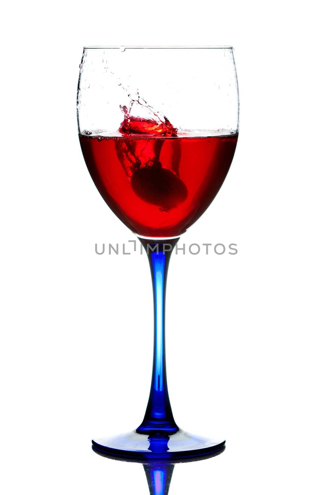 The red wine pouring into a wine glass.
