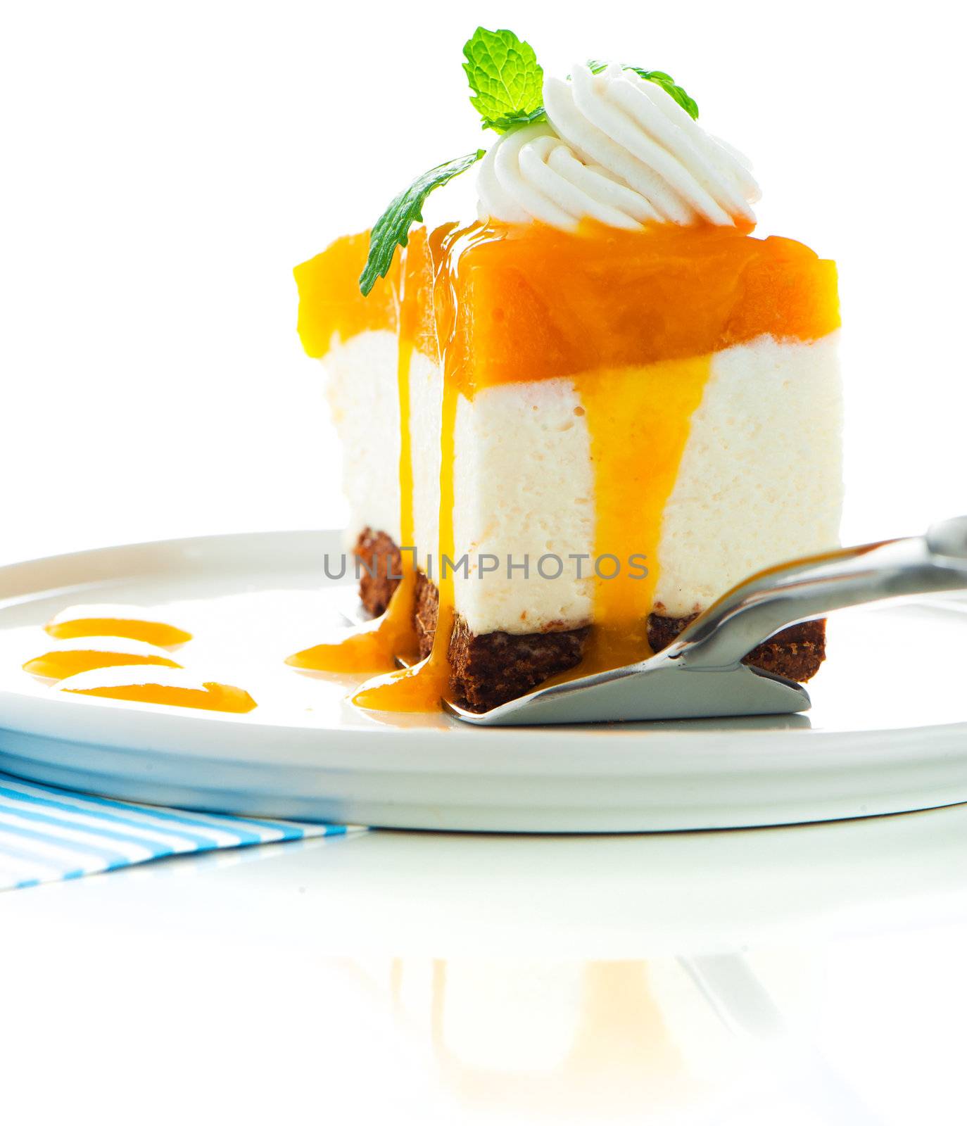 A piece of mango cheese cake on white background as a studio shot