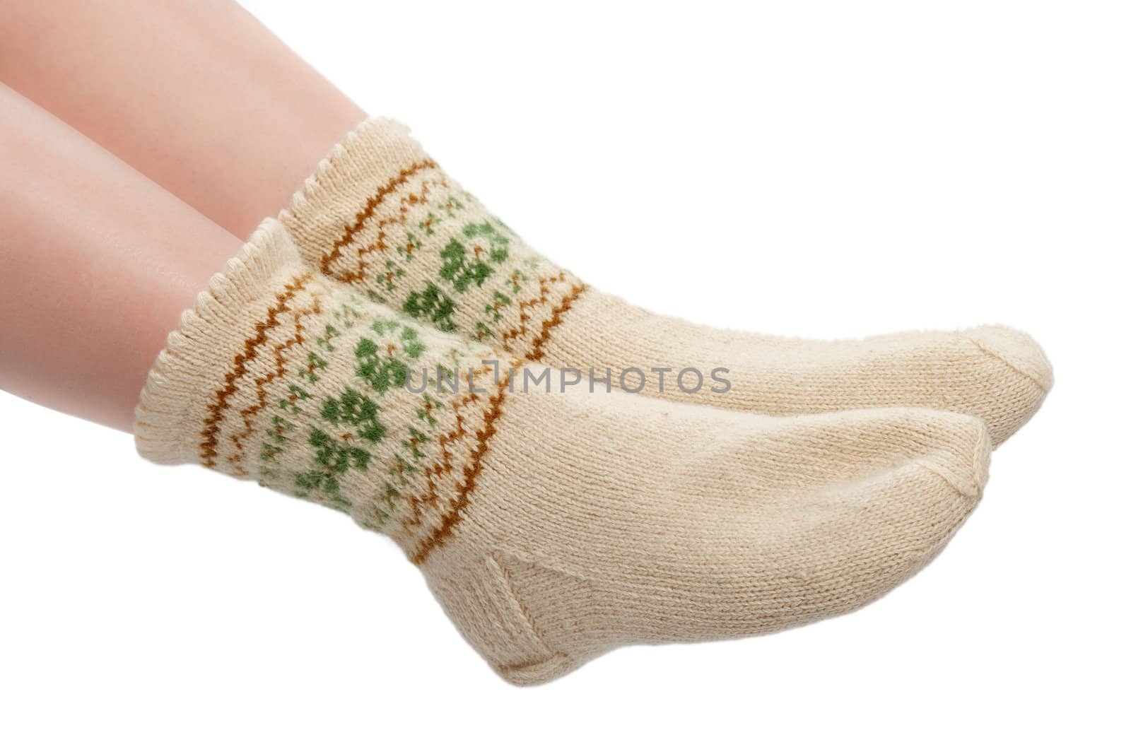 woman's legs in warm woolen socks isolated on a white background