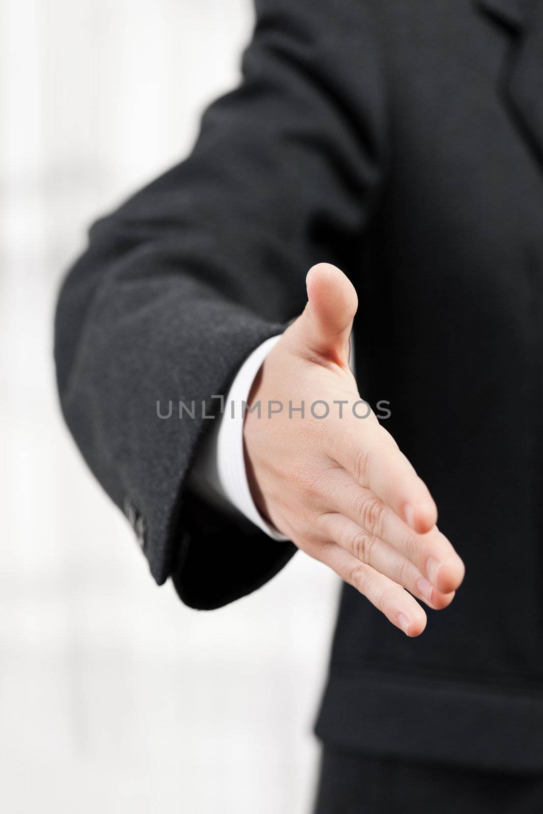 Businessman in black suit gesturing hand greeting or meeting handshake