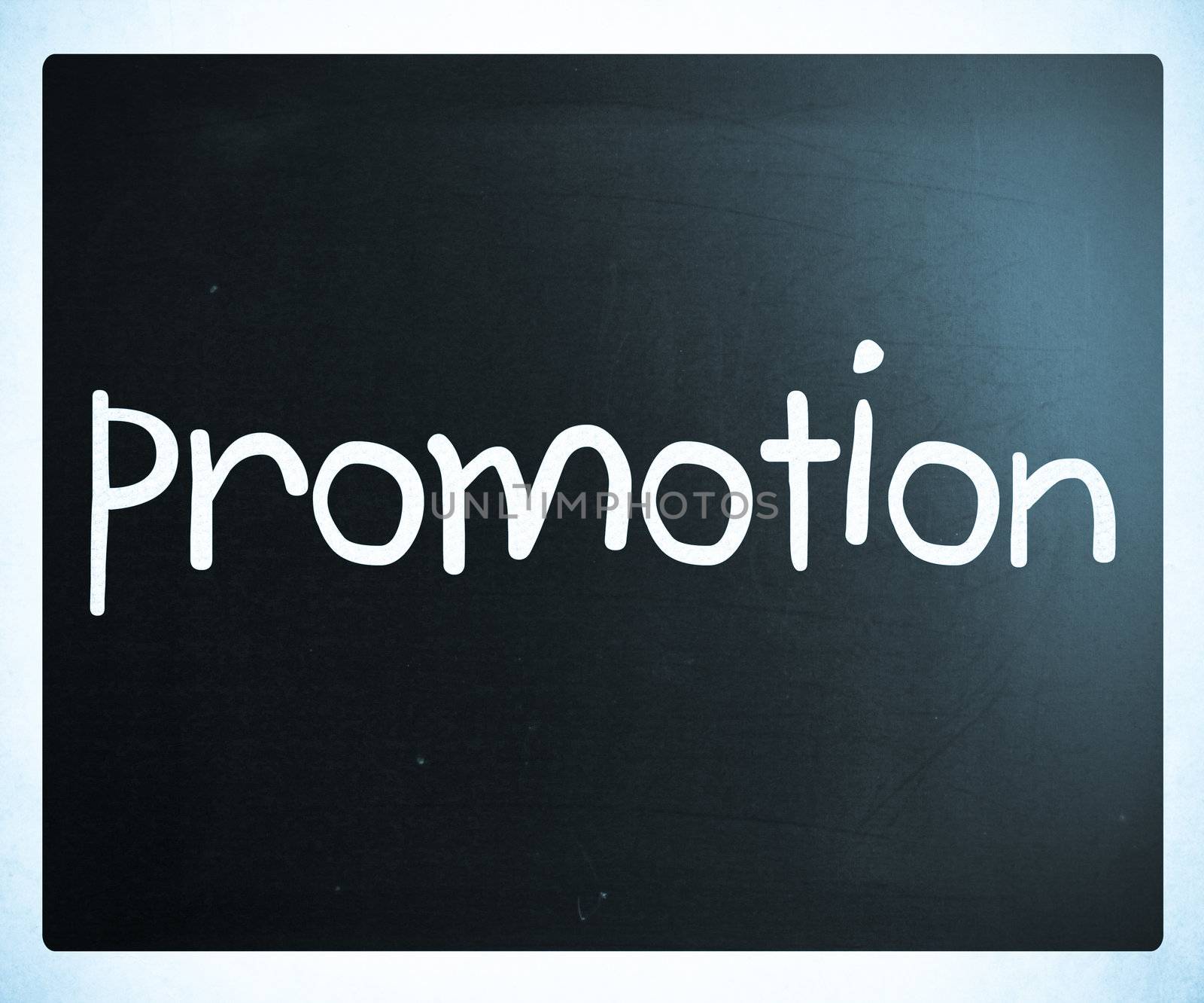 The word "promotion" handwritten with white chalk on a blackboard