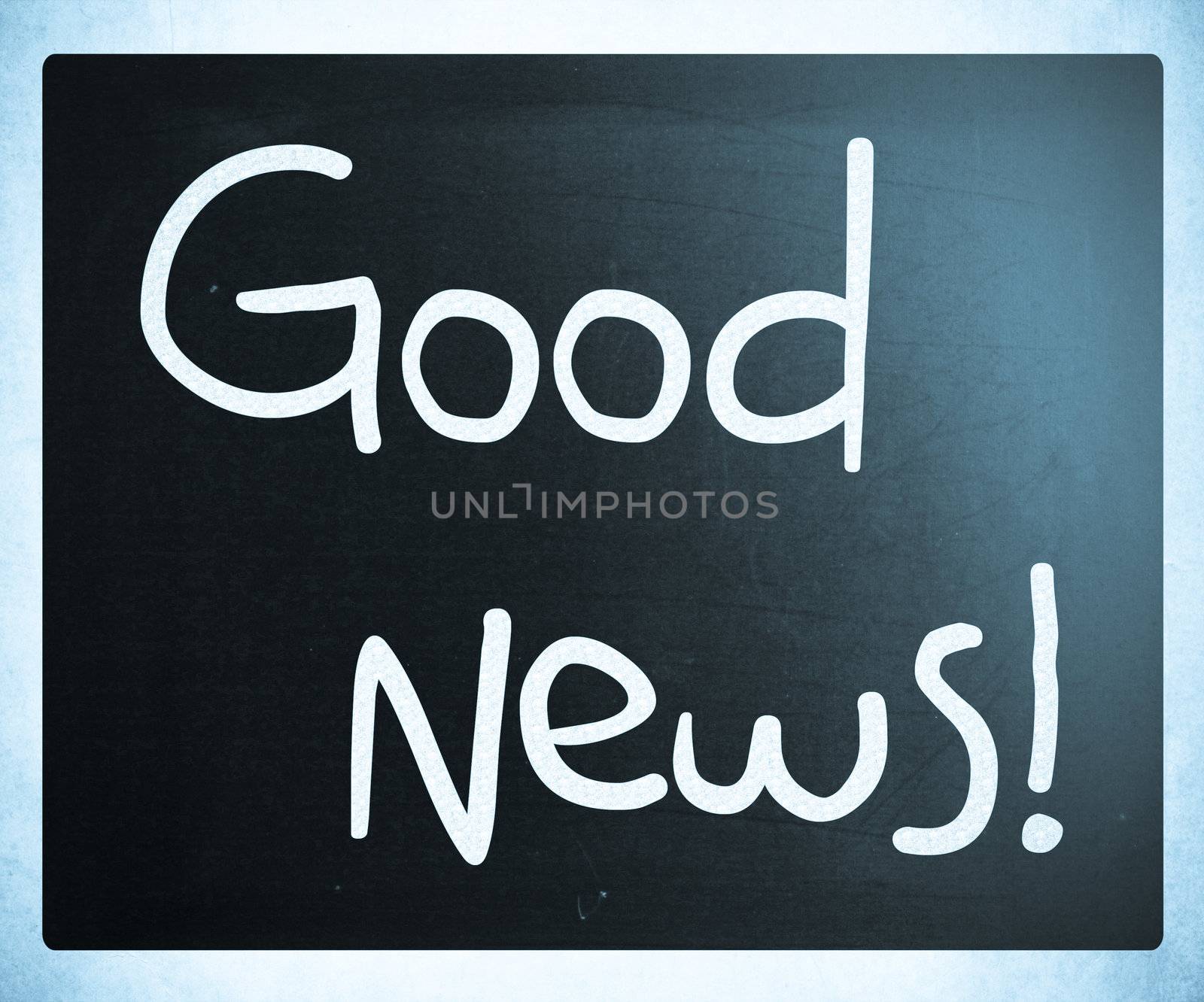 "Good News!" handwritten with white chalk on a blackboard