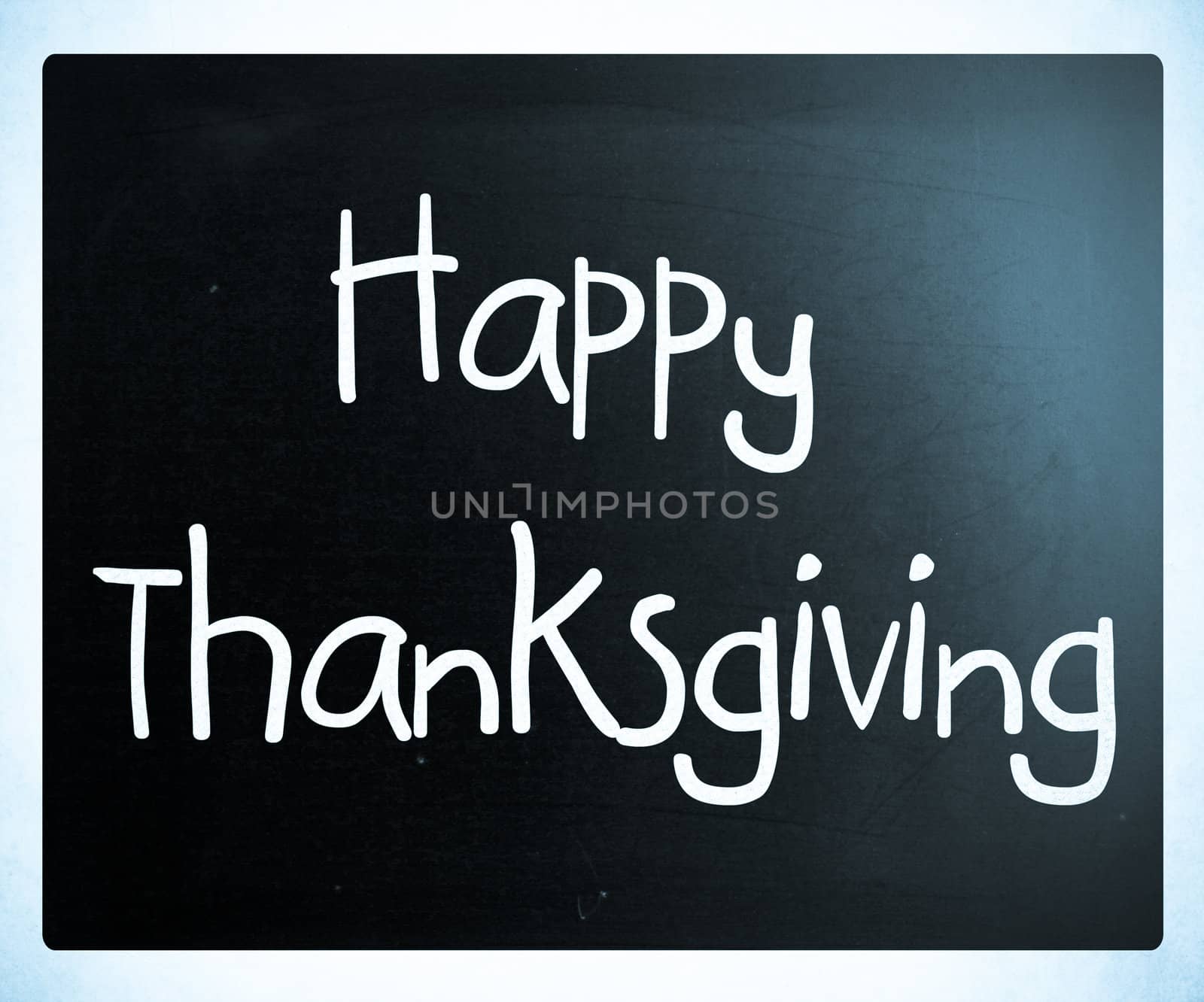 "Happy Thanksgiving" handwritten with white chalk on a blackboard