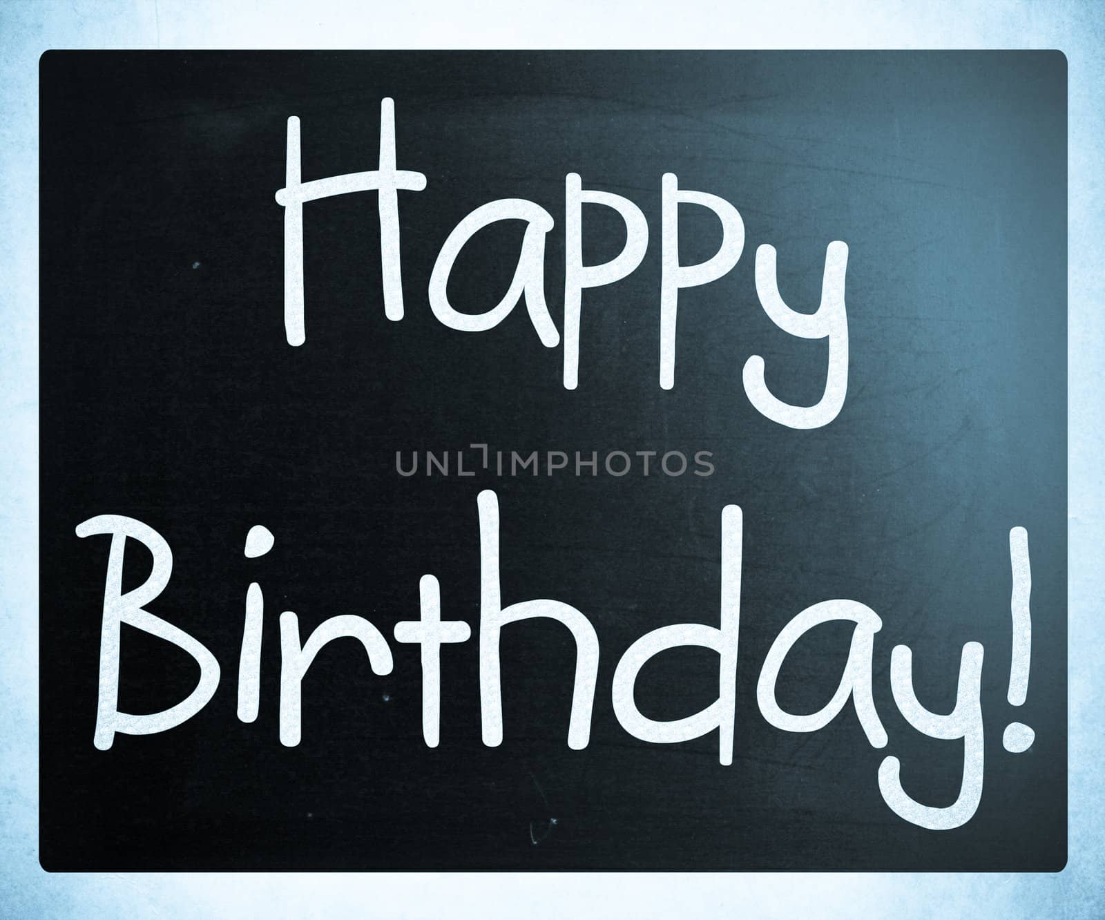 "Happy Birthday" handwritten with white chalk on a blackboard