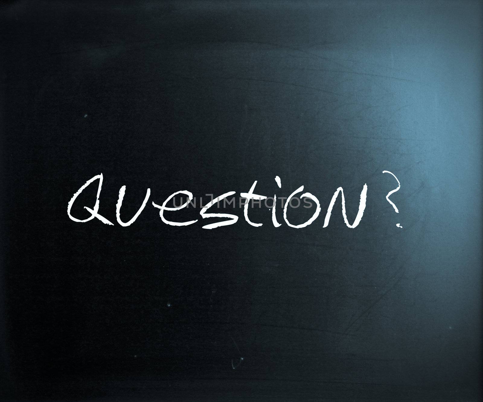 "Question" handwritten with white chalk on a blackboard.