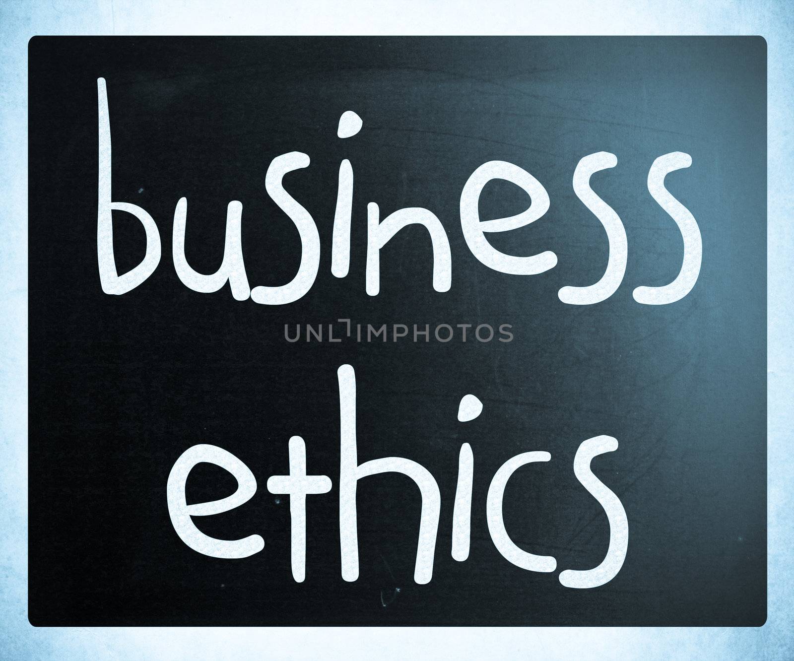 "Business Ethics" handwritten with white chalk on a blackboard