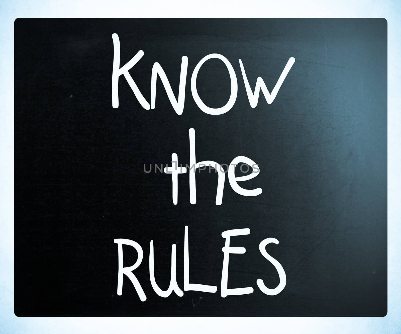 "Know the rules" handwritten with white chalk on a blackboard