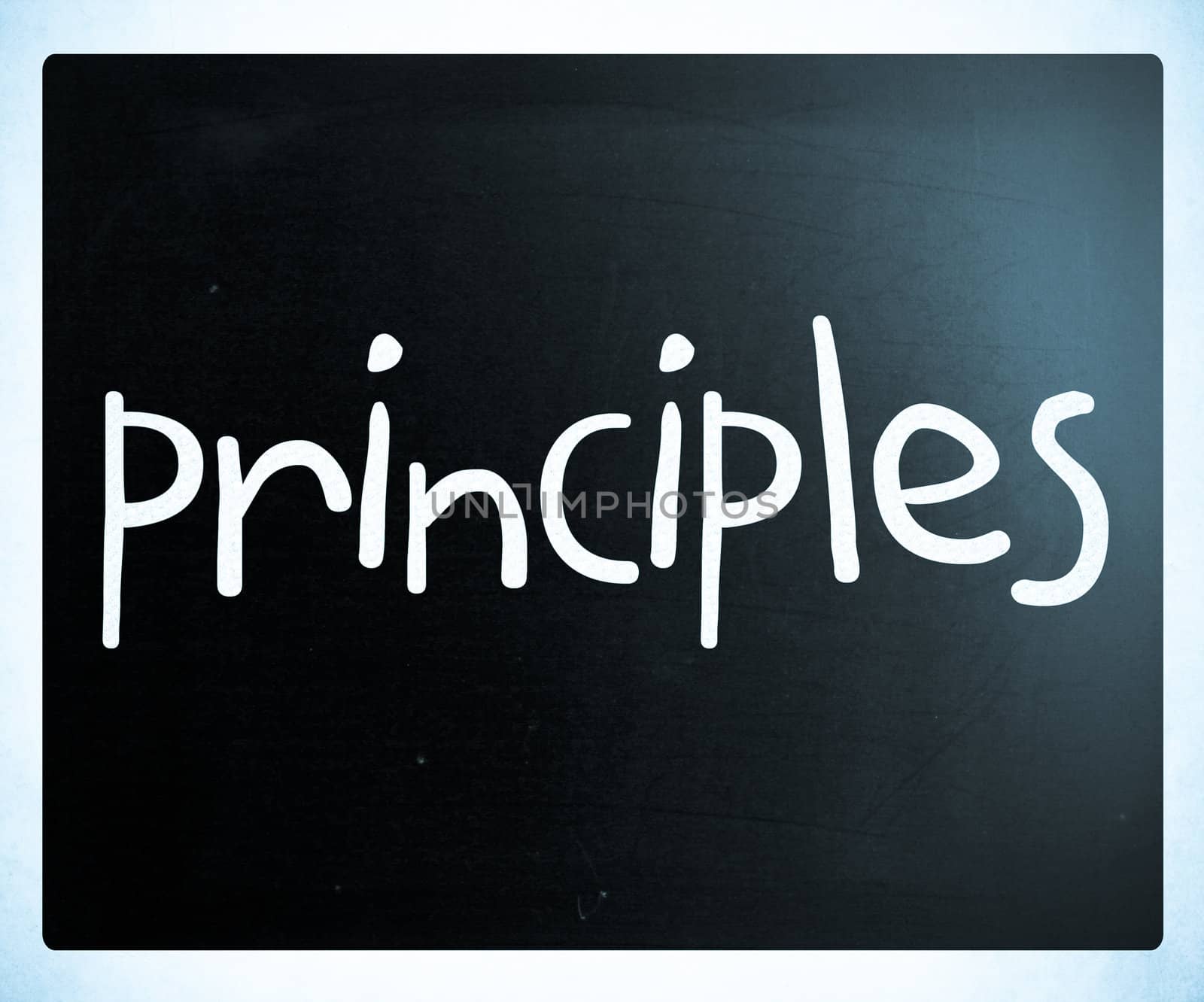 "Principles" handwritten with white chalk on a blackboard