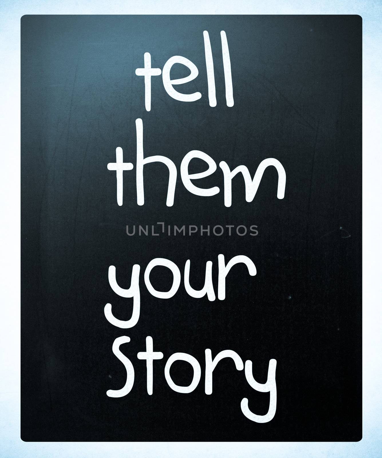 "Tell them your story" handwritten with white chalk on a blackboard