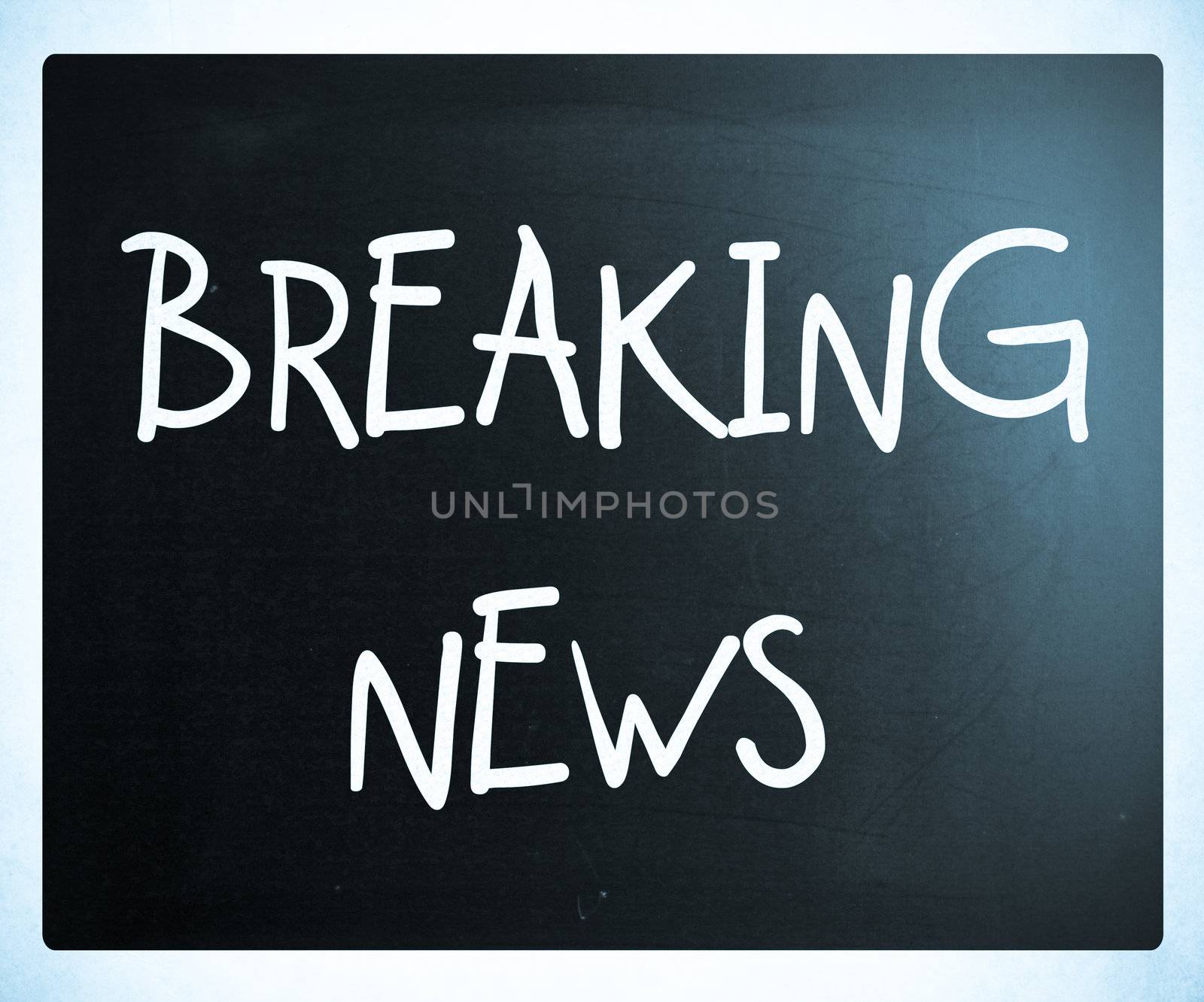 "Breaking news" handwritten with white chalk on a blackboard