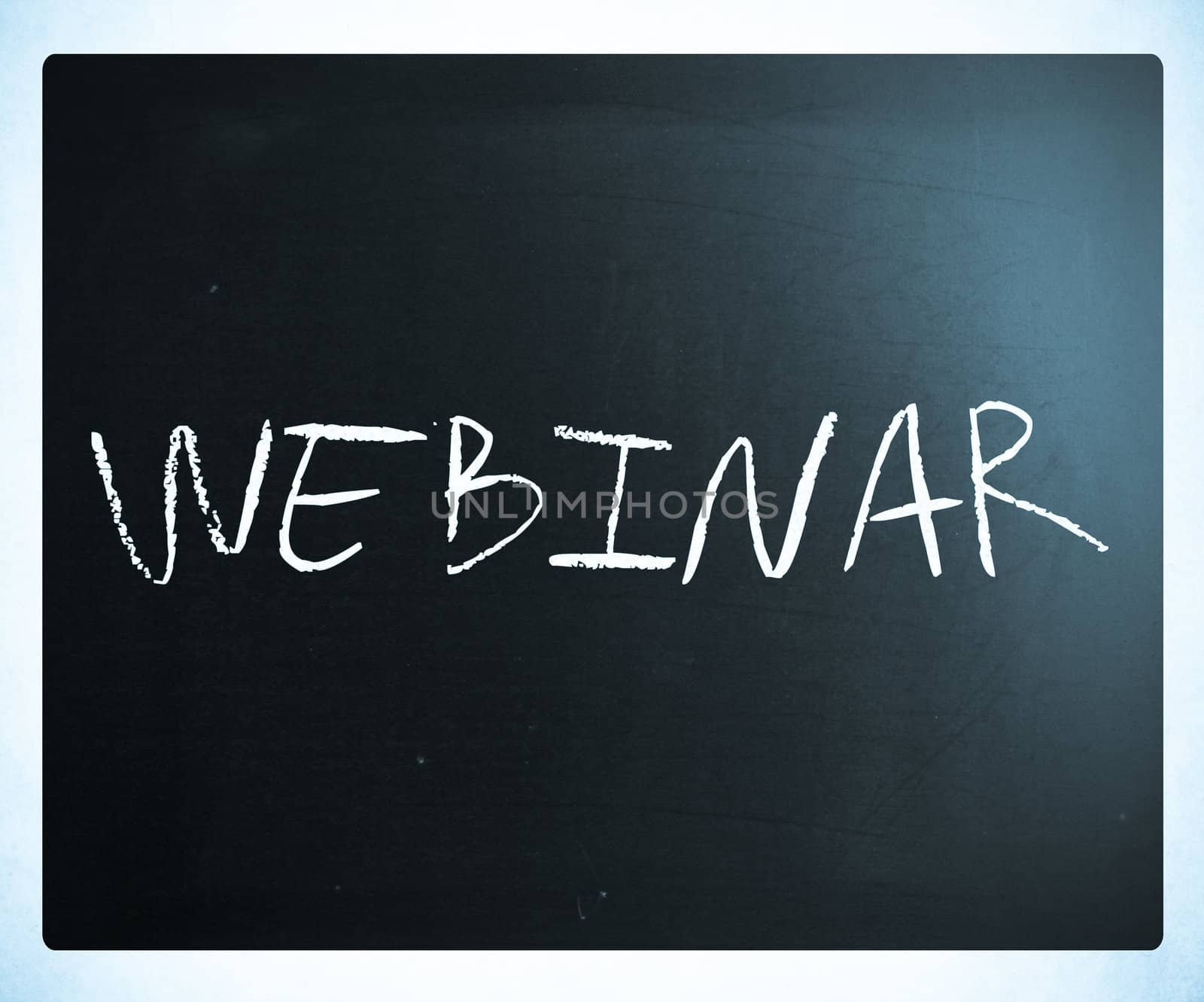 The word "Webinar" handwritten with white chalk on a blackboard.