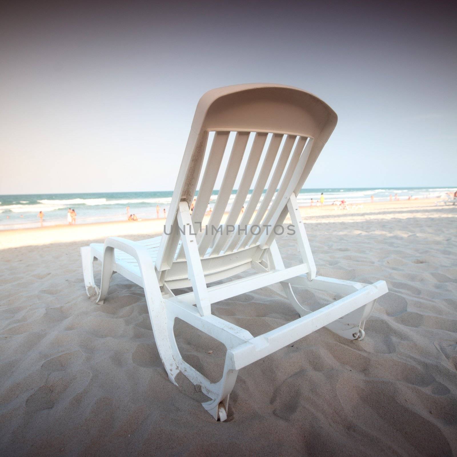 chair on sand and ocean background