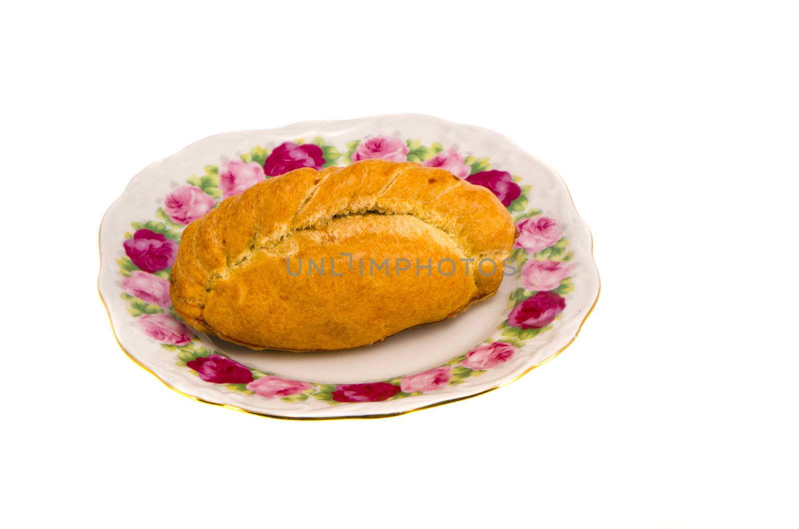 Karaite pastry stuffed with chopped lamb in decorative flower dish isolated on white background.