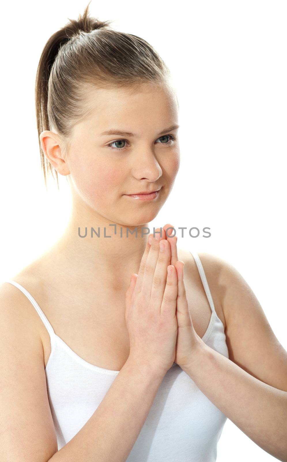 Young girl doing yoga moves, or meditating at home by stockyimages