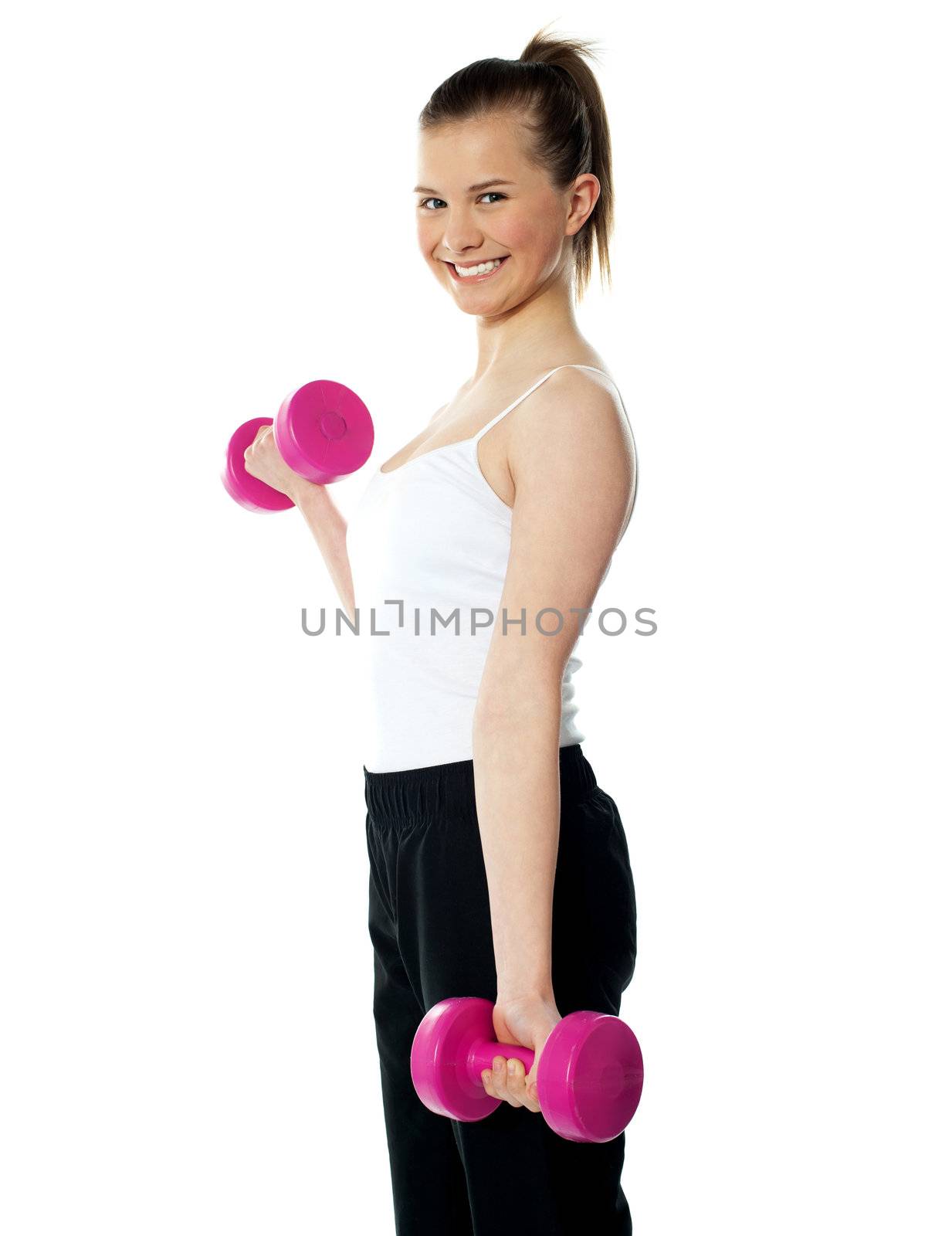 Strong teenager working out with dumbbells. Shot in studio on a white background