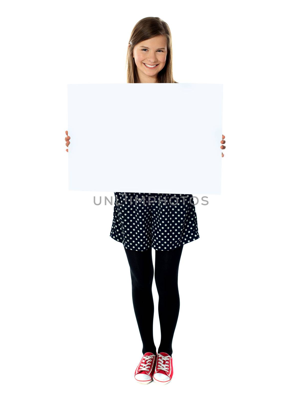 Attractive smiling cute girl holding blank poster by stockyimages