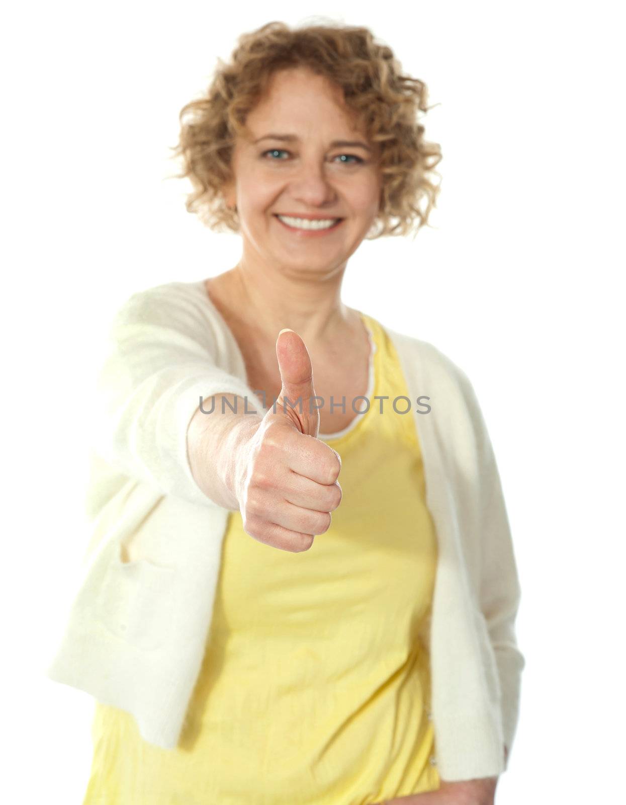 Glamorous woman gesturing thumbs-up by stockyimages