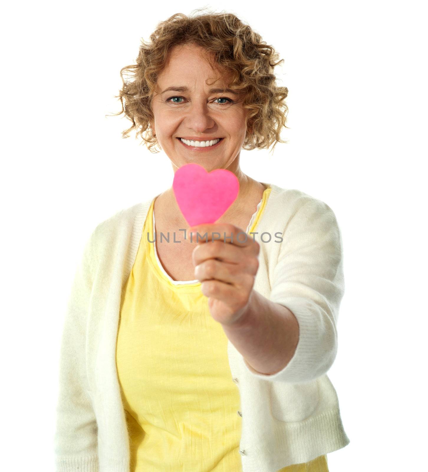 Happy woman offering her heart by stockyimages