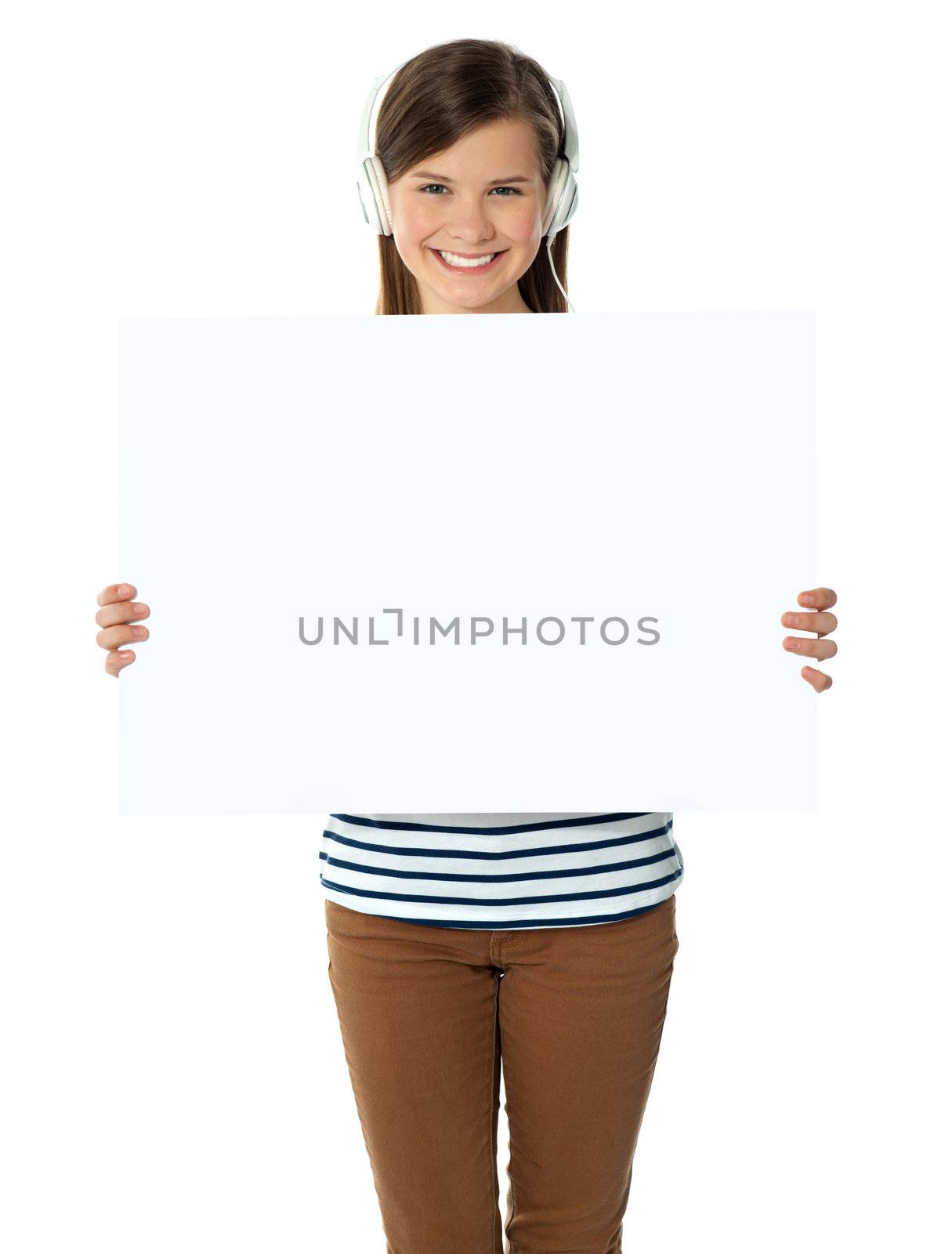 Musical girl promoting blank banner ad. Studio shot