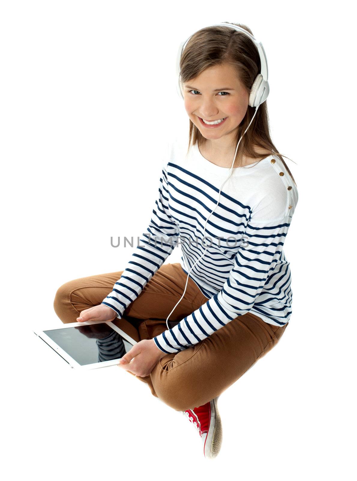 Pretty girl enjoying music on headphones isolated on white background