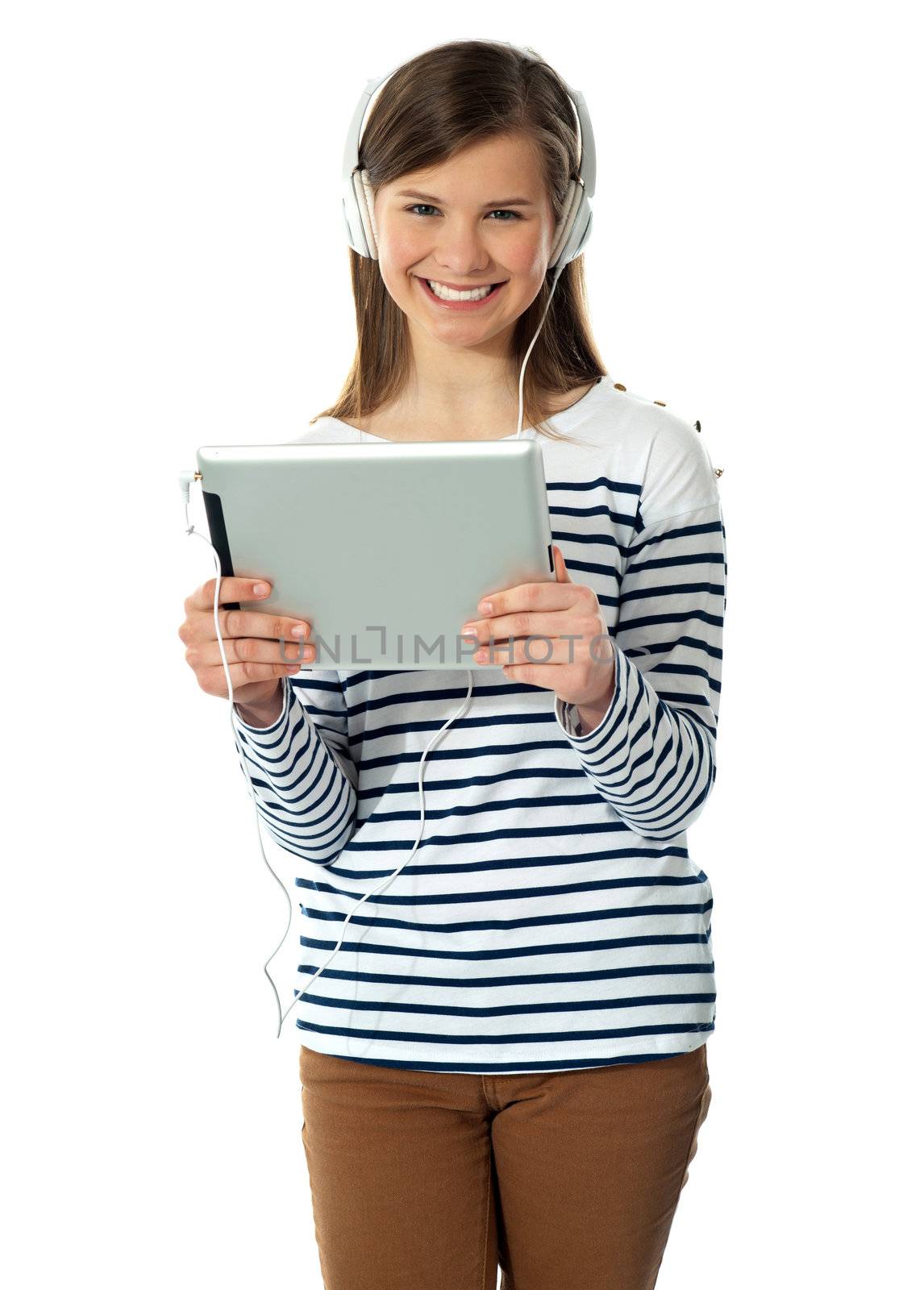 Gorgeous teenager enjoying music by stockyimages